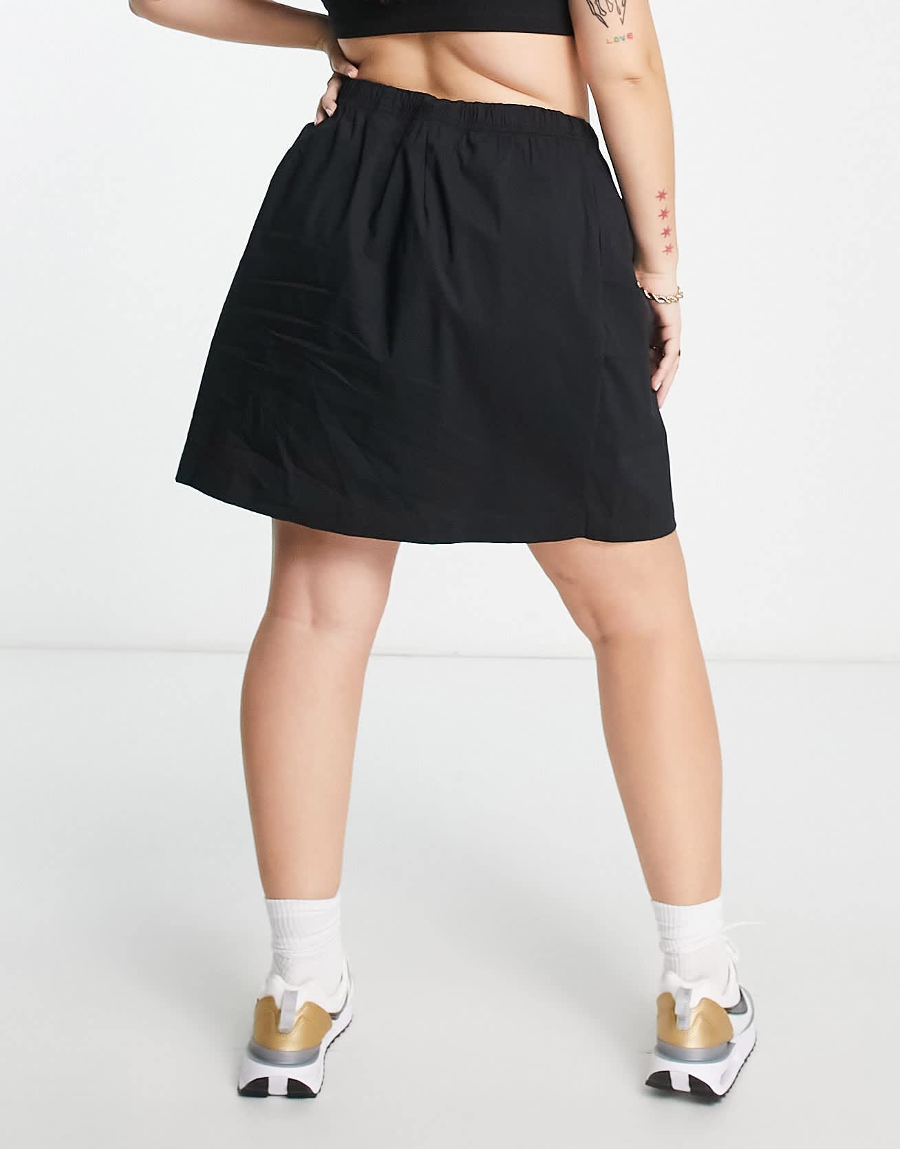 Nike Plus Essential woven high waisted skirt in black