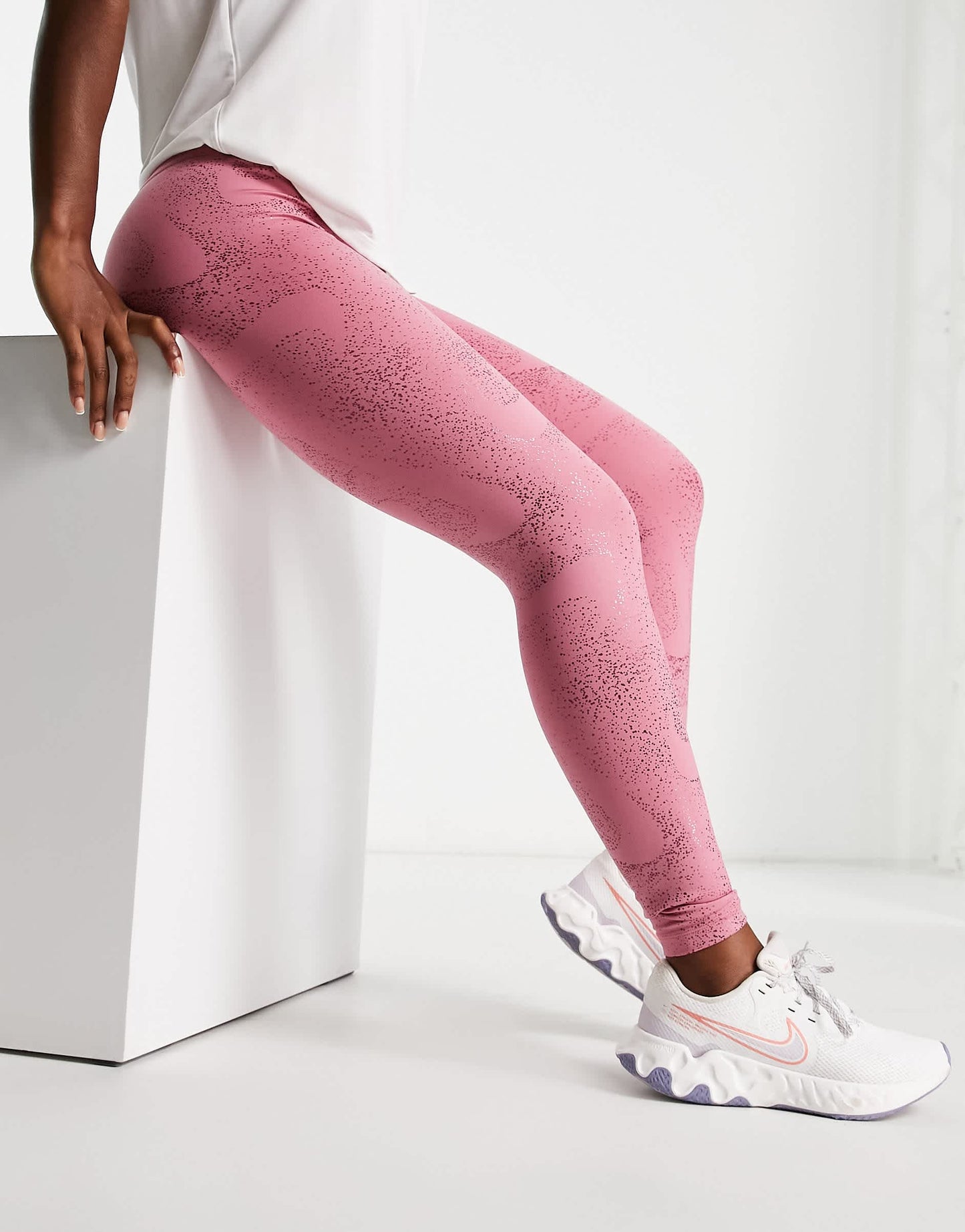 Nike One Training Dri-FIT glitter printed mid rise leggings in pink