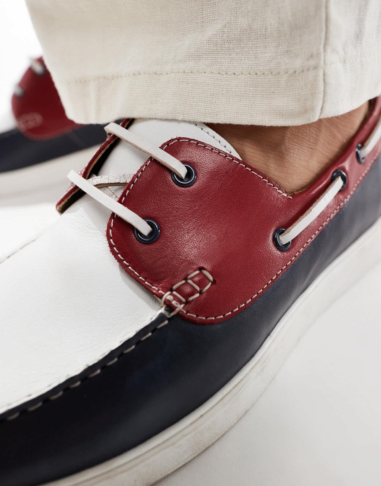 ASOS DESIGN lace up boat shoes in navy suede with red and white details