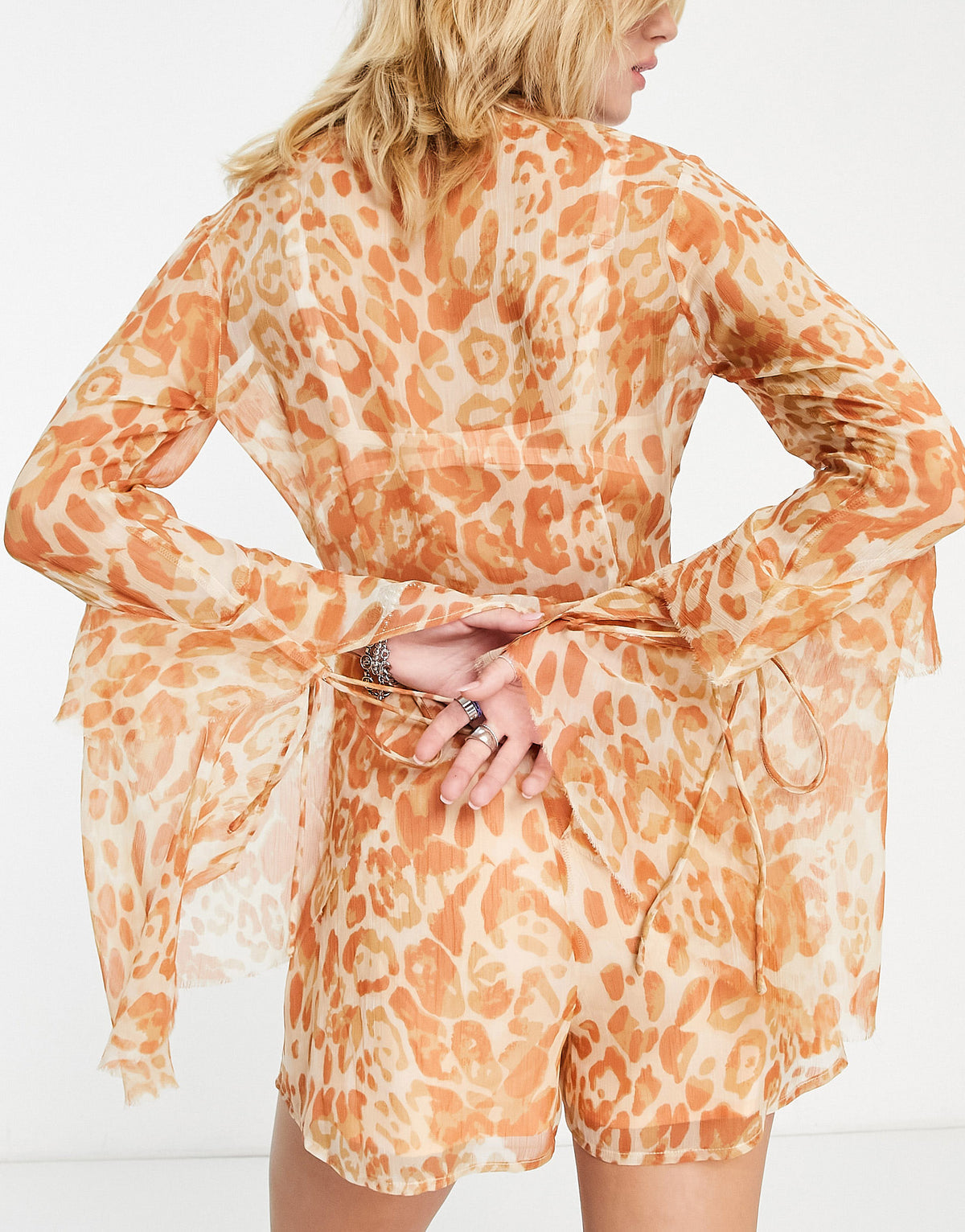 ASOS DESIGN deep v neck ruffle sleeve playsuit in washed leopard print