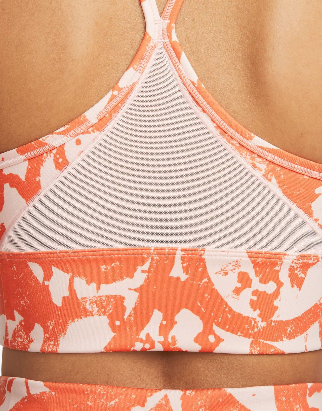 Nike Training Dri-FIT Indy Icon Clash all over print bra in orange
