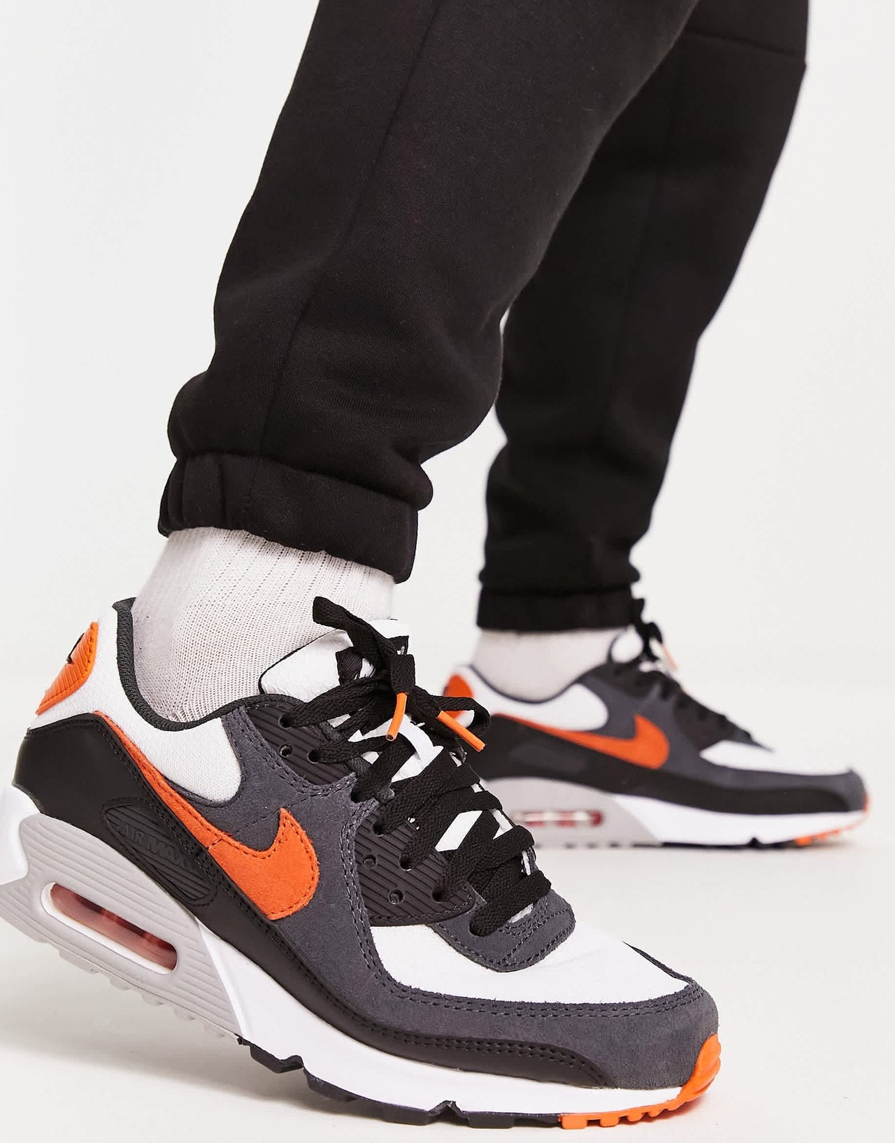 Nike air max 90 trainers in black and orange