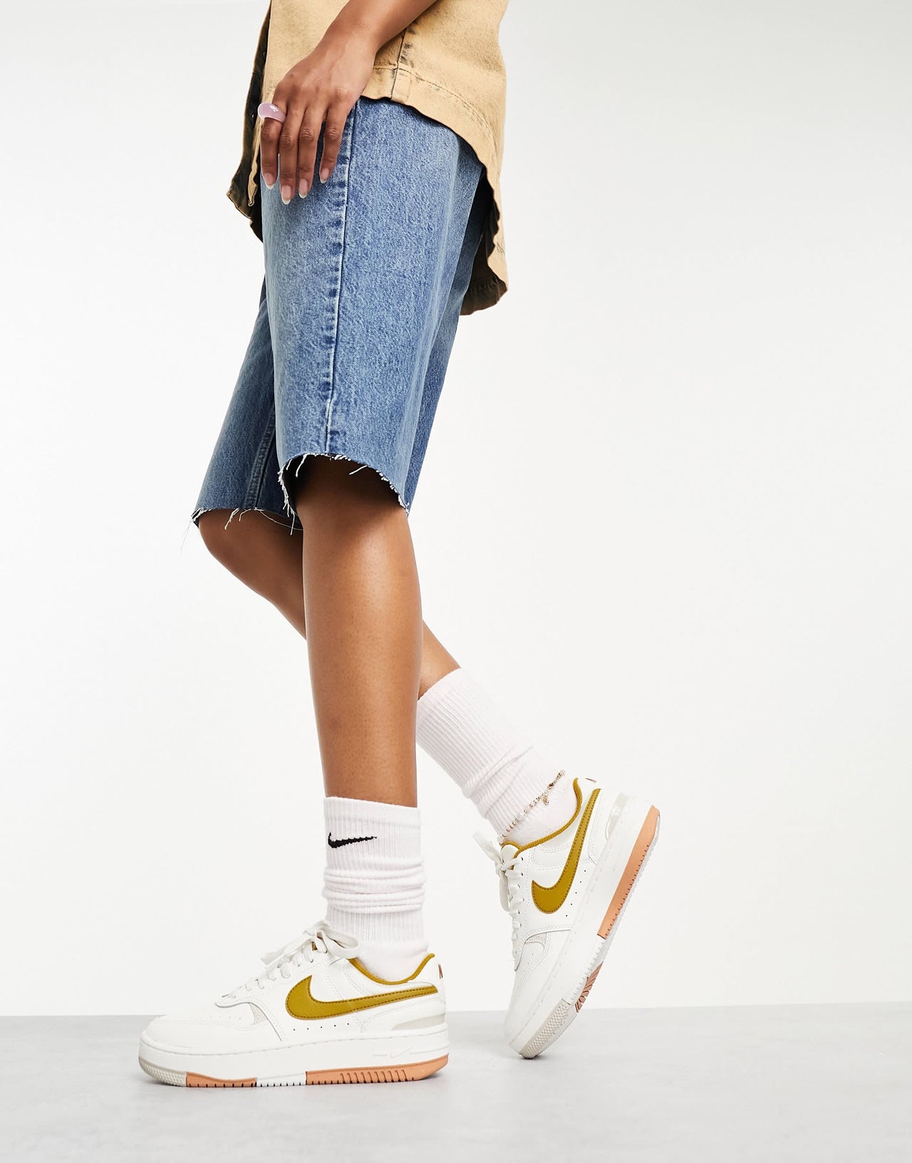 Nike Gamma Force trainers in ivory & gold