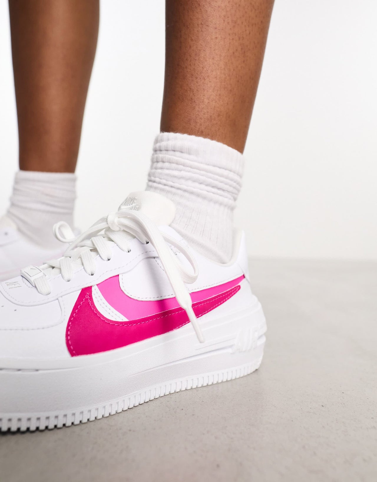 Nike Air Force 1 PLT.AF.ORM trainers in white and fierce pink