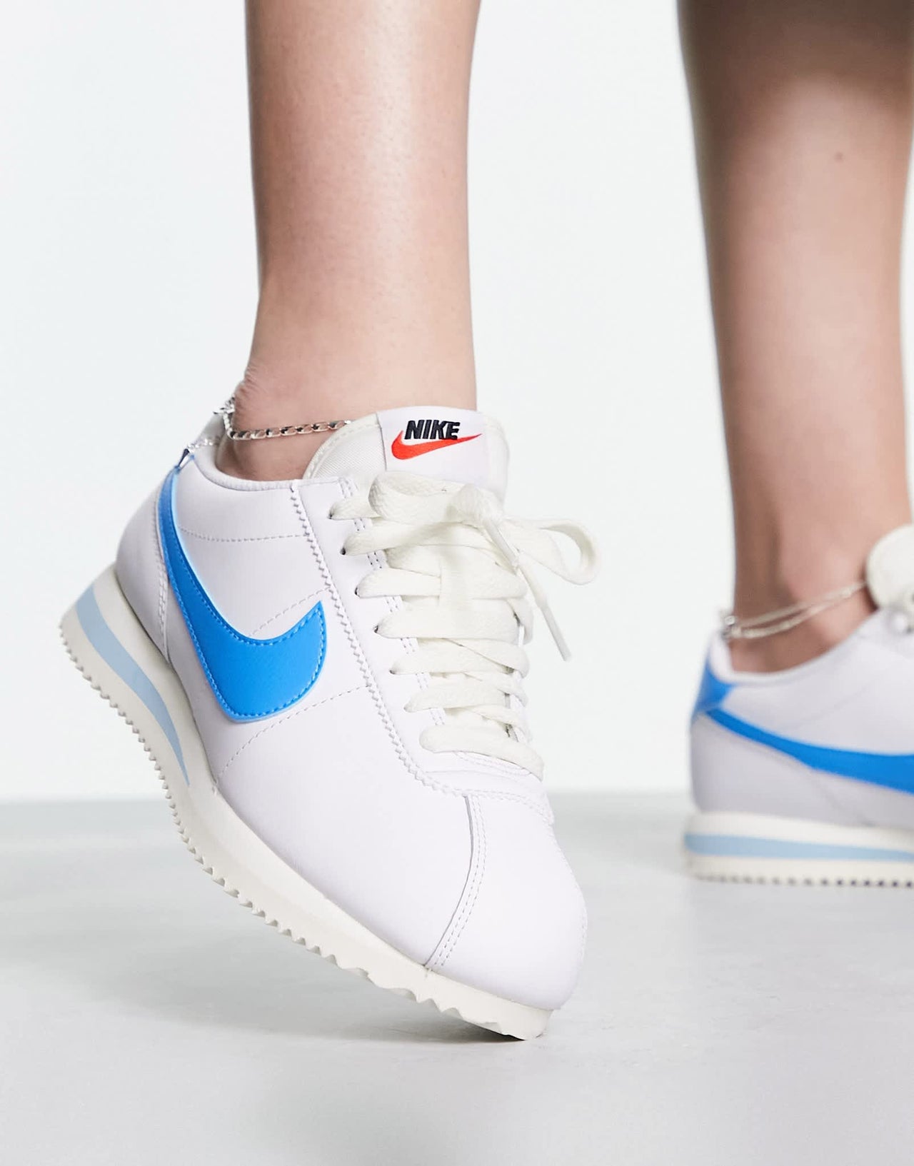Nike Cortez leather trainers in off white and university blue