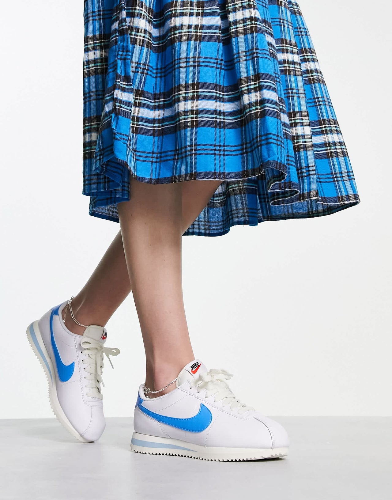 Nike Cortez leather trainers in off white and university blue