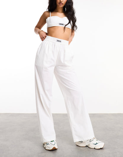 Weekend Collective woven trousers with label in white