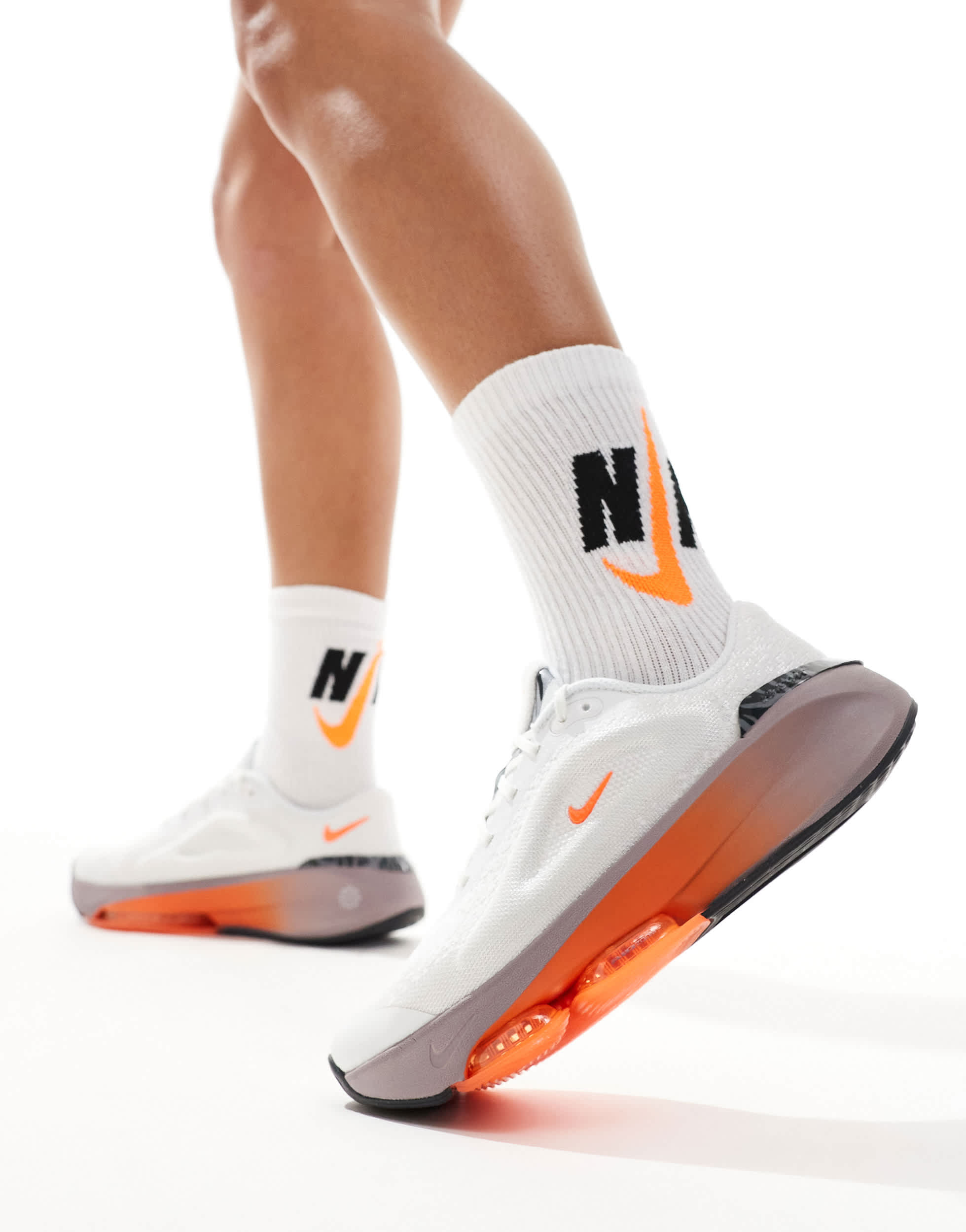 Nike Training Versair trainers in white and orange