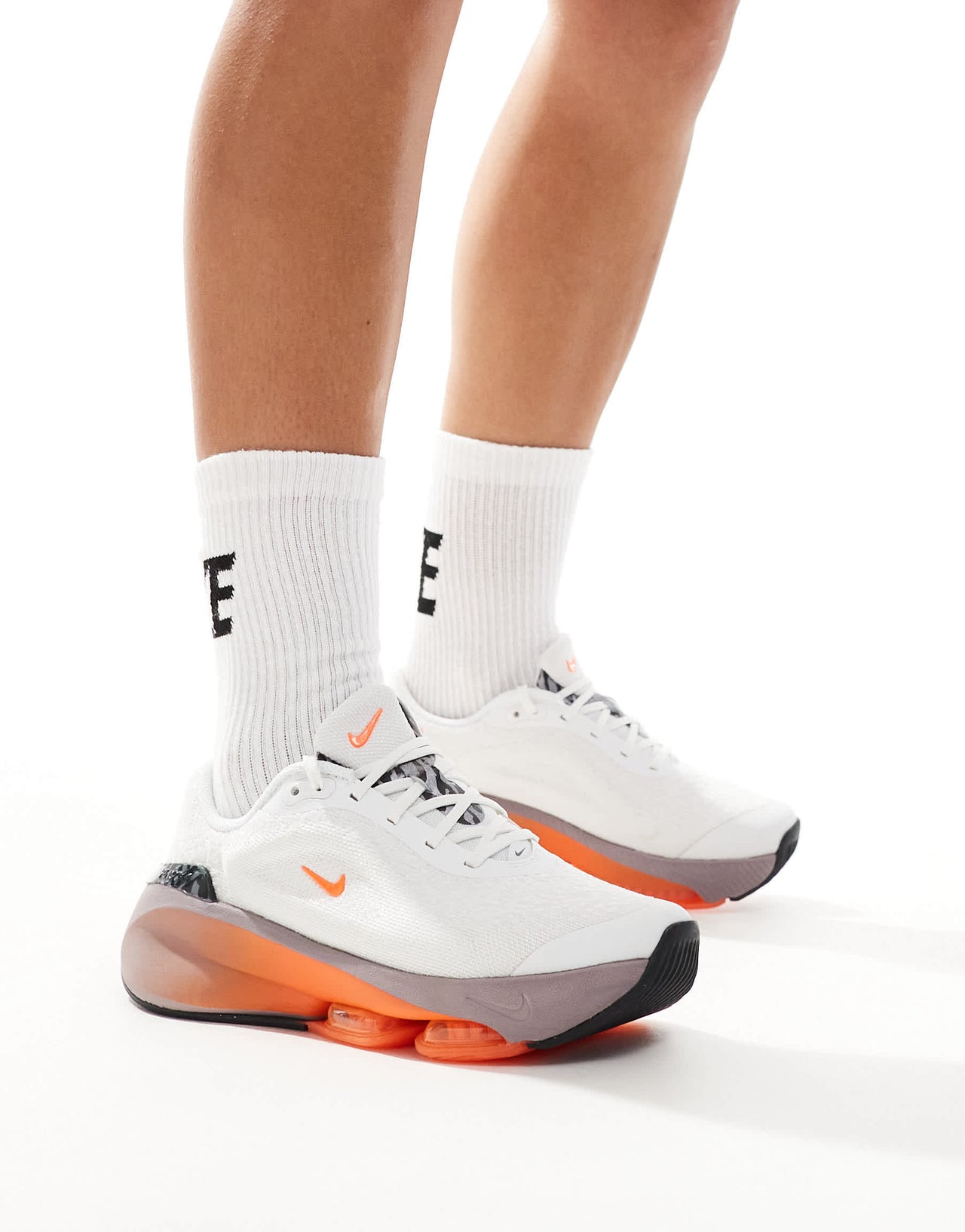 Nike Training Versair trainers in white and orange