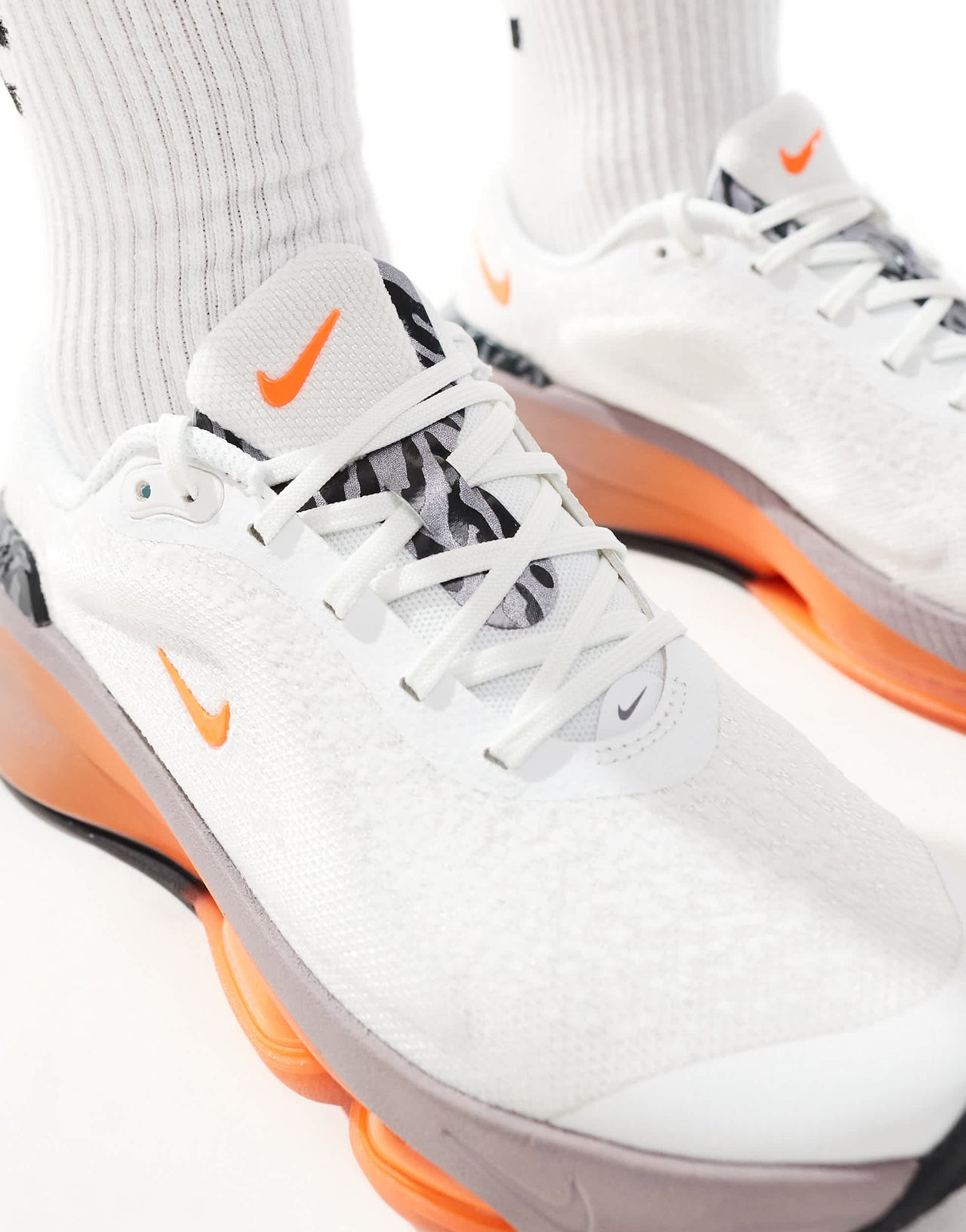 Nike Training Versair trainers in white and orange