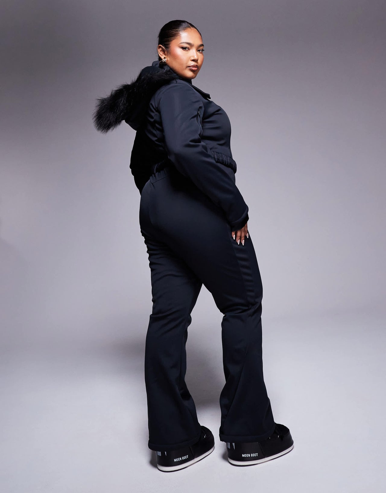 4505 Curve Icon belted ski suit with slim kick leg and faux fur hood in black