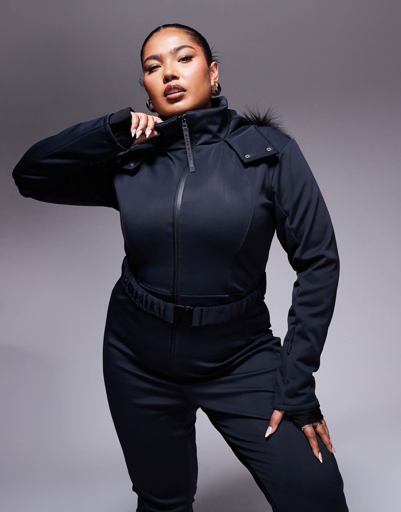 4505 Curve Icon belted ski suit with slim kick leg and faux fur hood in black