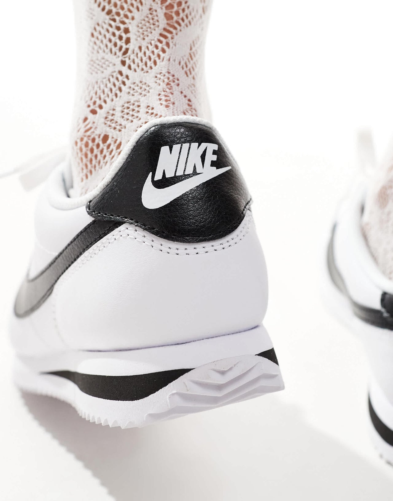 Nike Cortez trainers in white and black