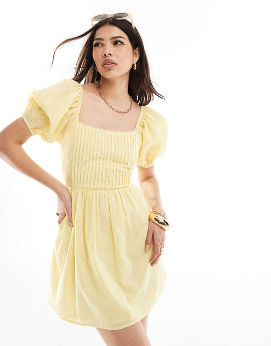 ASOS DESIGN cotton dobby mini dress with lace up back in yellow