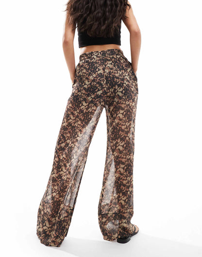 ASOS DESIGN pull on trousers with sheer overlay in abstract print
