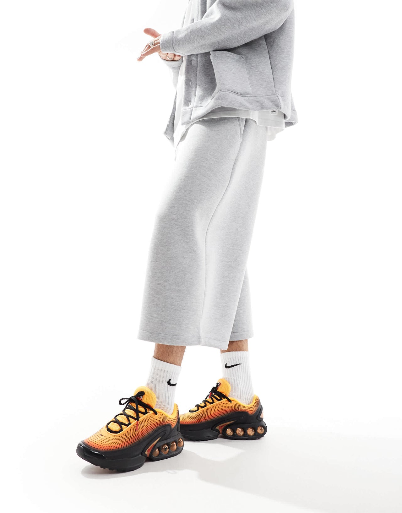 Nike Air Max DN trainers in black and orange