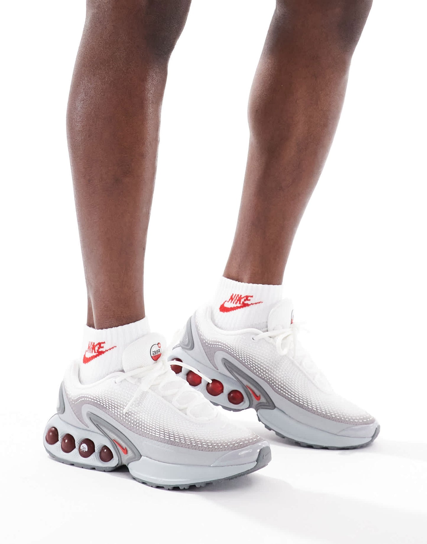 Nike Air Max DN trainers in grey and red