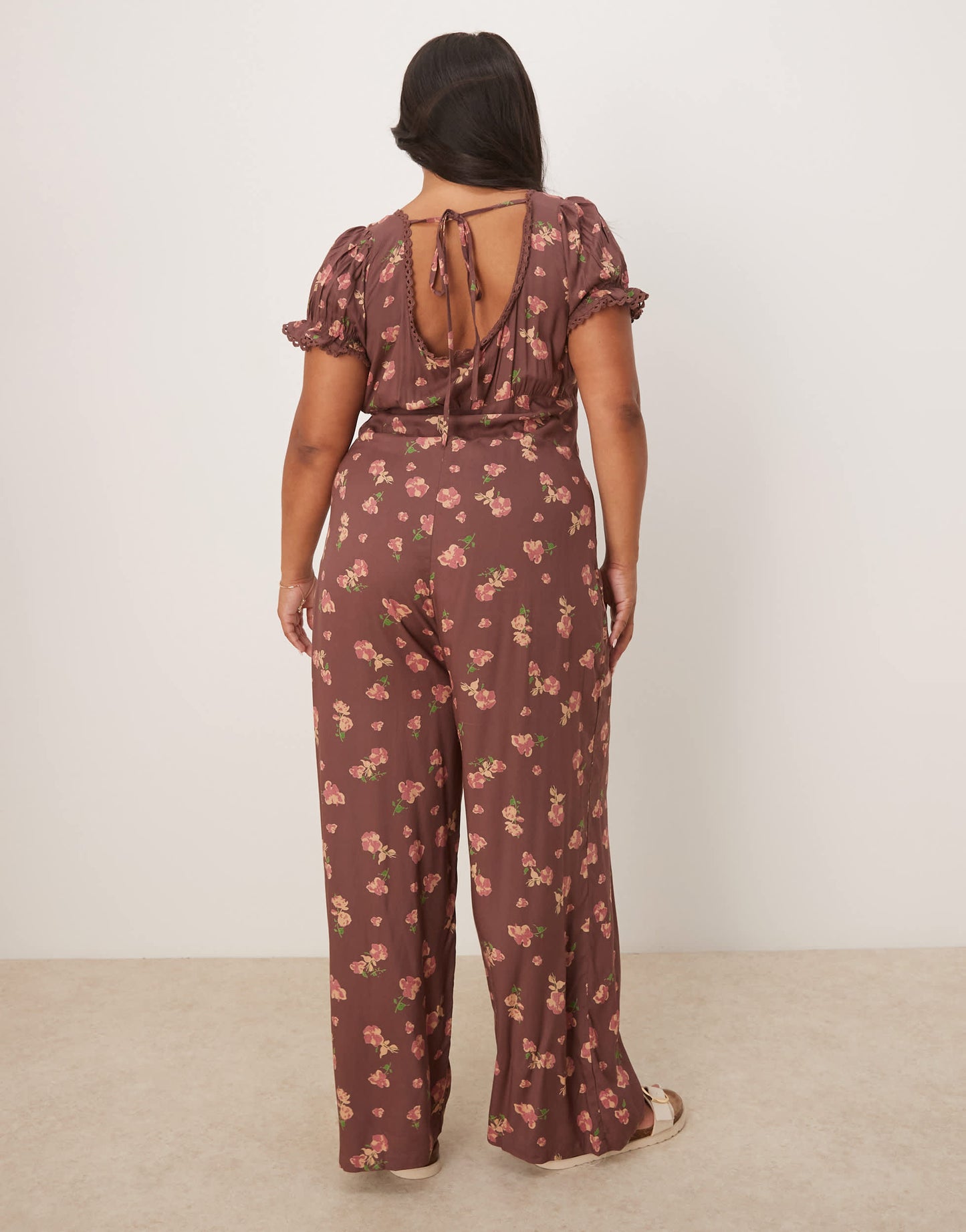 ASOS DESIGN Curve spun lace trim corset waist jumpsuit in mauve floral print