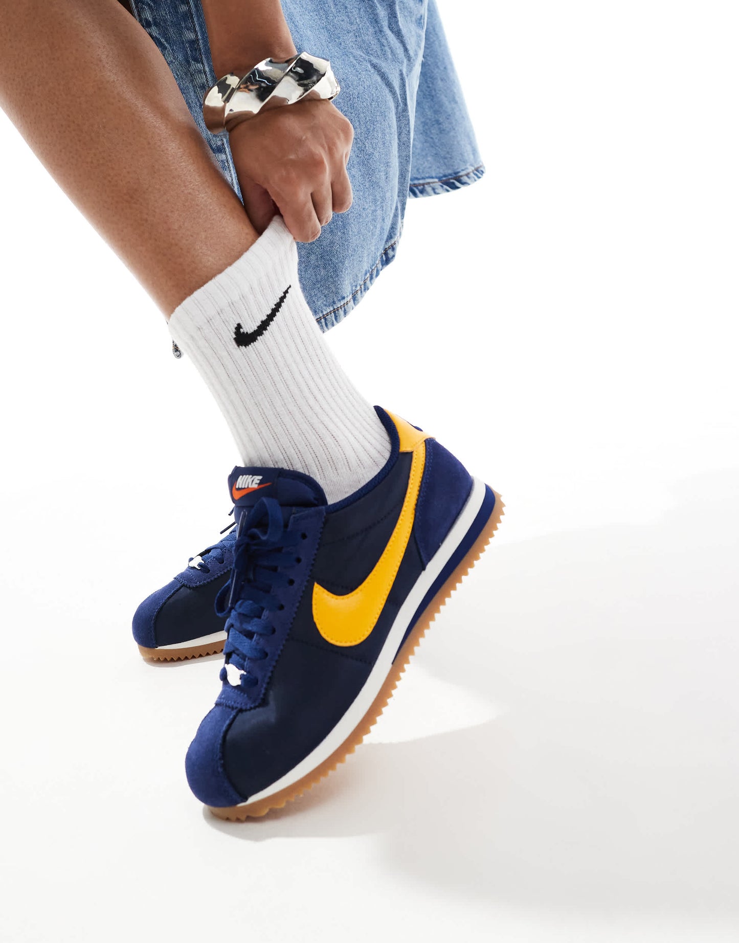 Nike Cortez trainers in navy and yellow