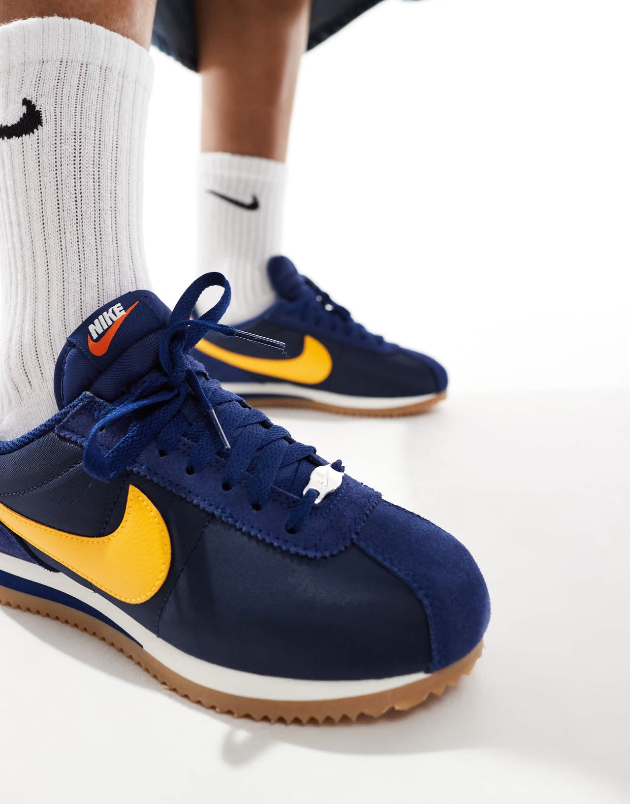 Nike Cortez trainers in navy and yellow