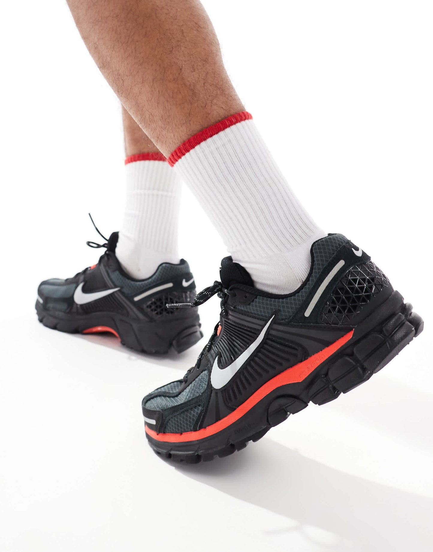 Nike Zoom Vomero 5 trainers in black and metallic silver