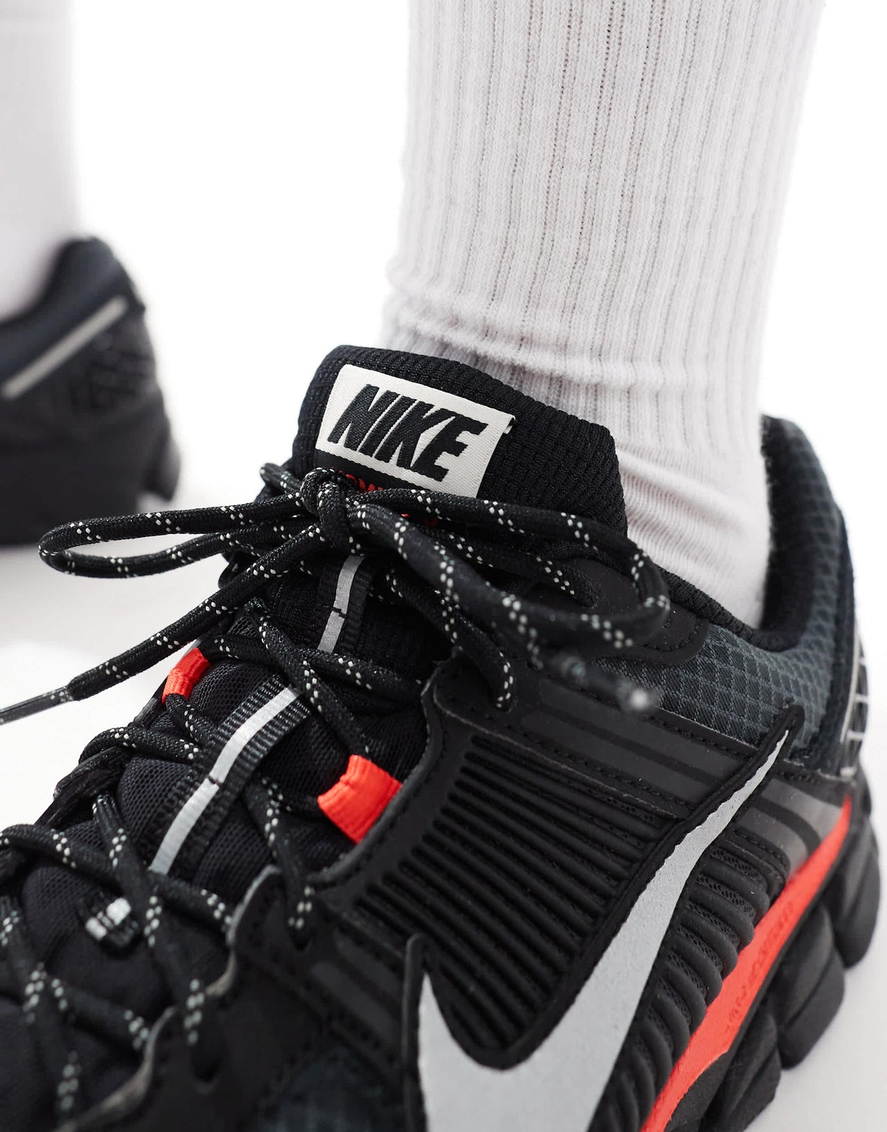Nike Zoom Vomero 5 trainers in black and metallic silver
