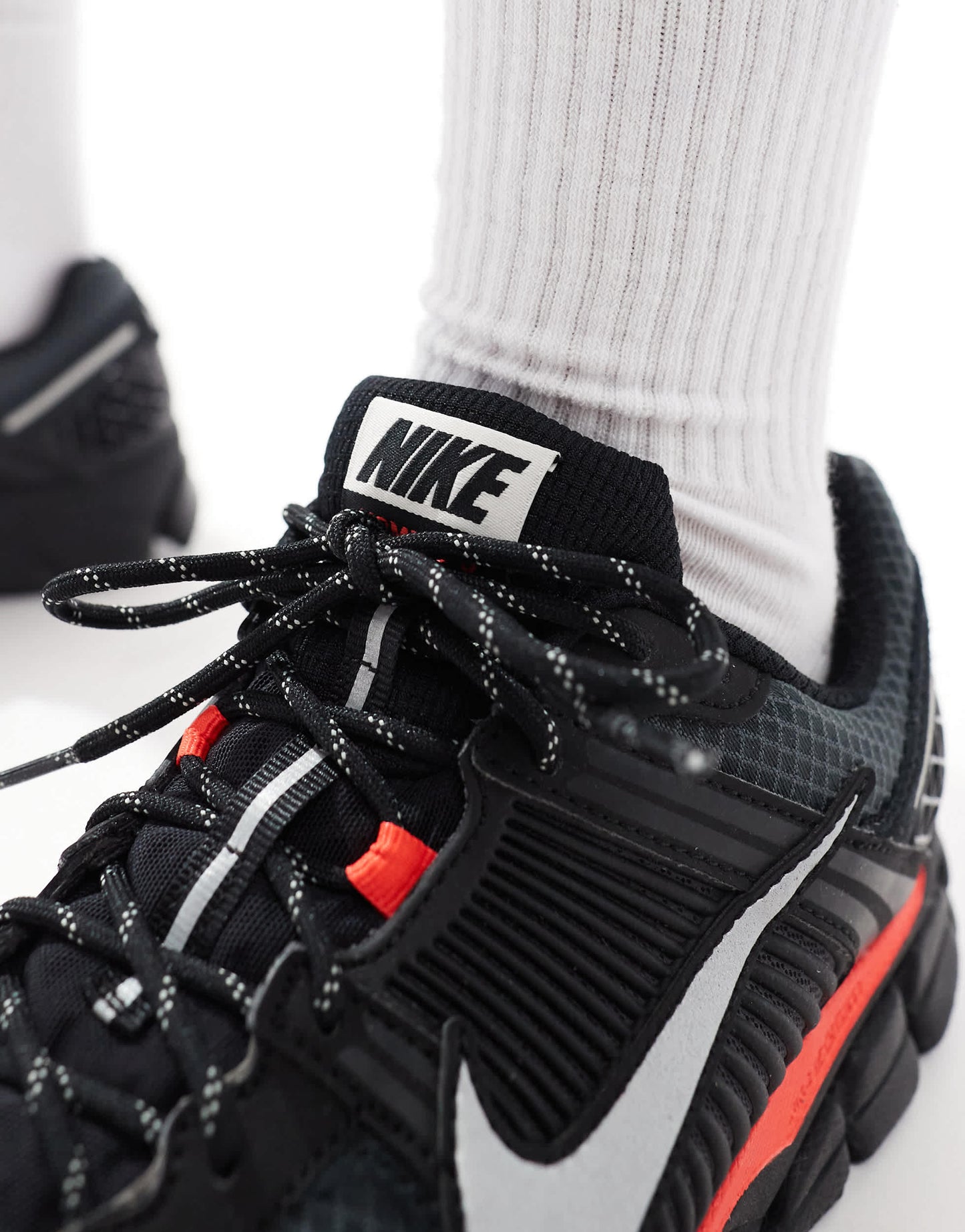 Nike Zoom Vomero 5 trainers in black and metallic silver