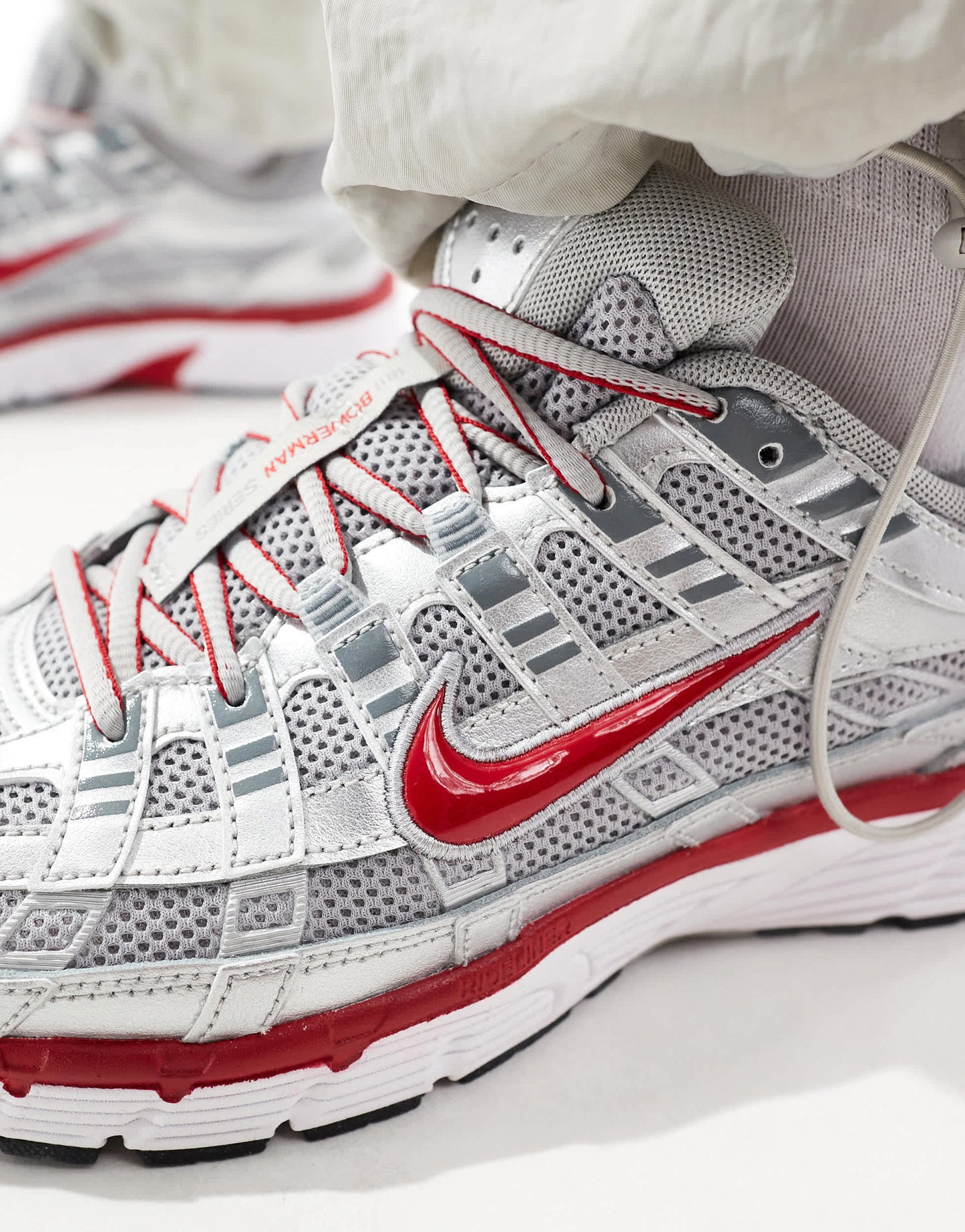 Nike P-6000 unisex trainers in metallic silver and red