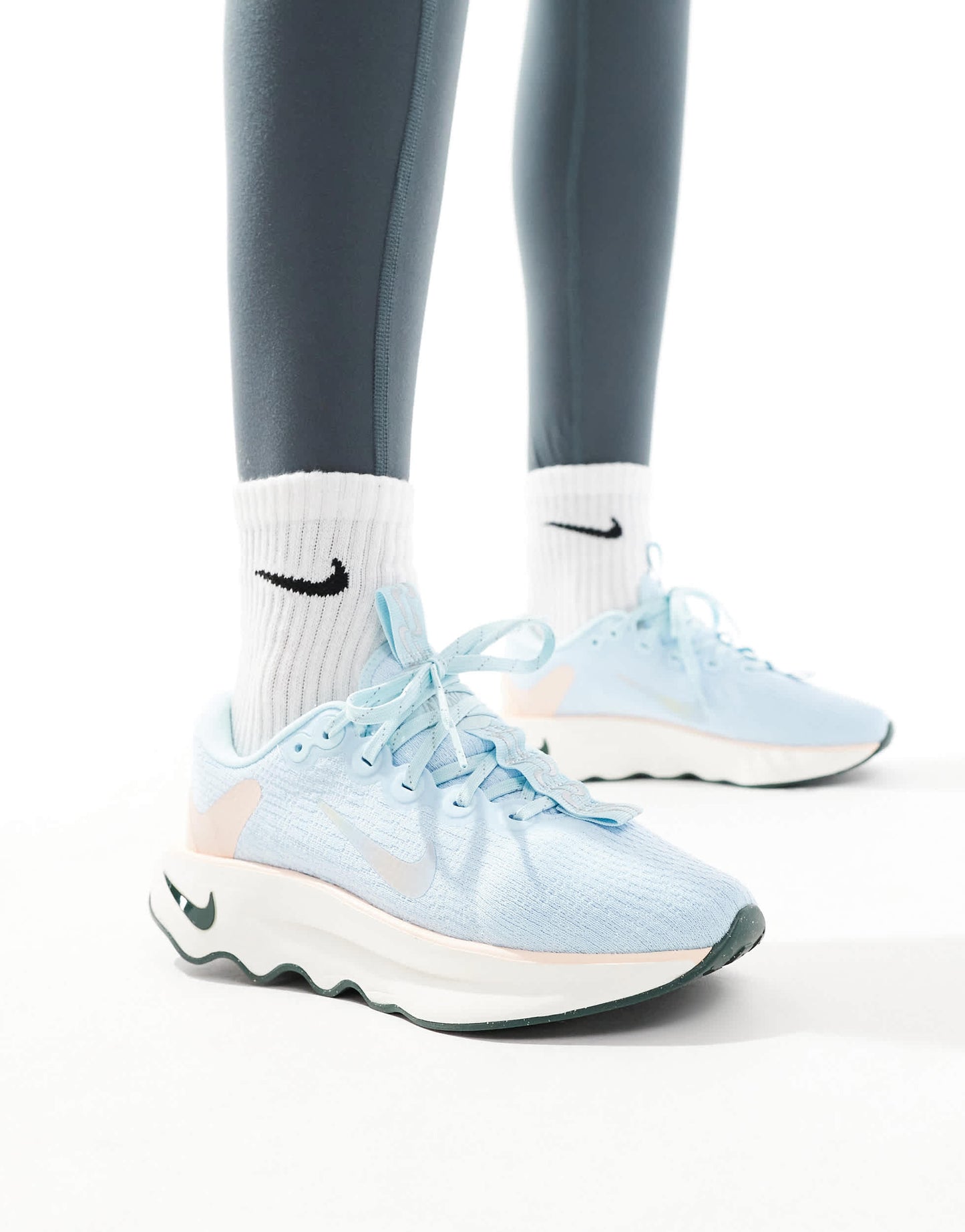 Nike Training Motiva trainers in light blue and white