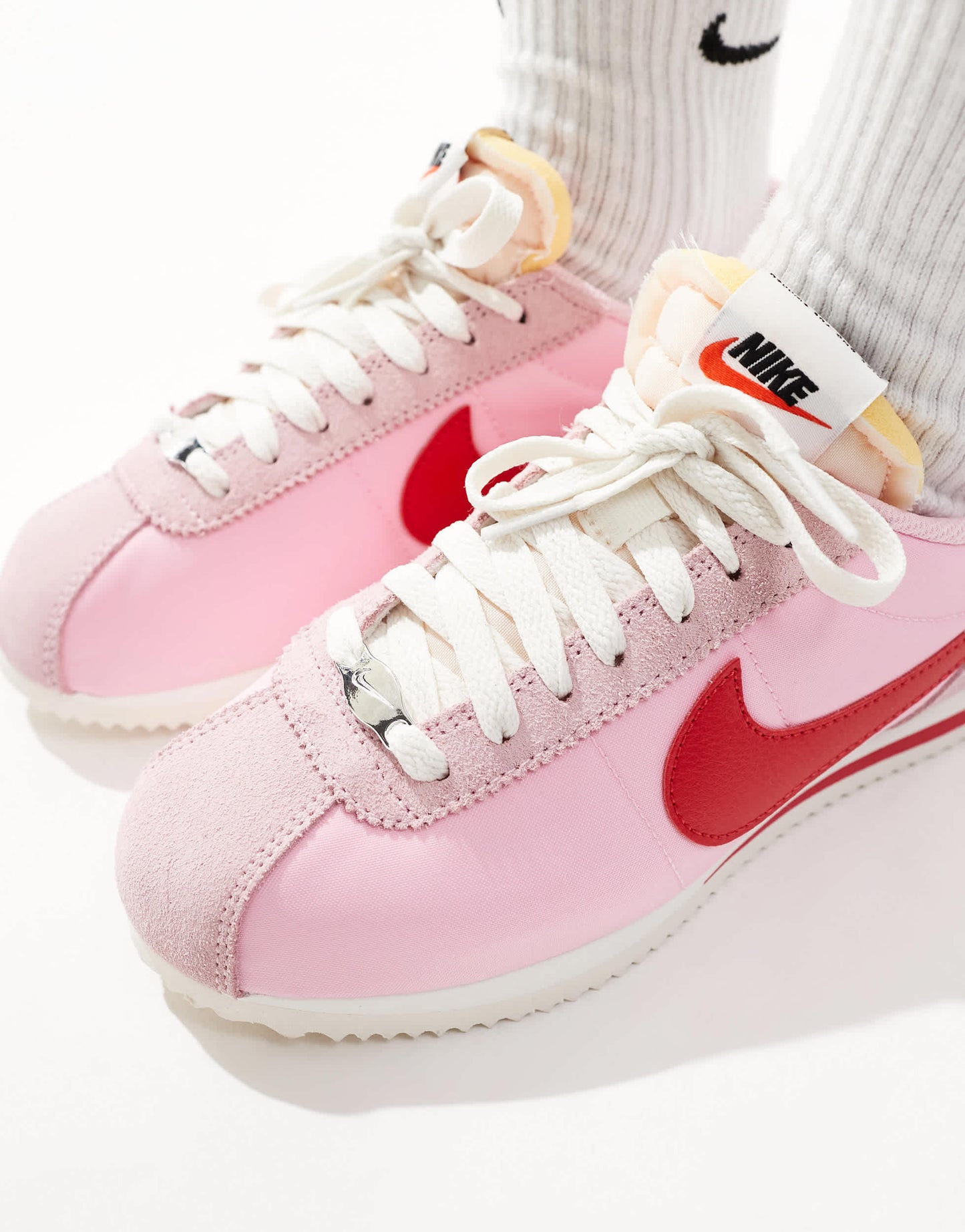 Nike Cortez TXT trainers in pink and red