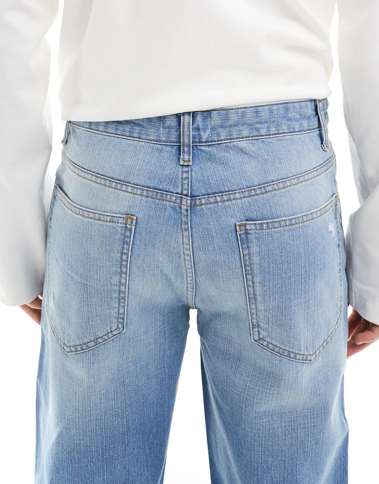 ASOS DESIGN wide flare jeans with tint & rips in mid wash blue