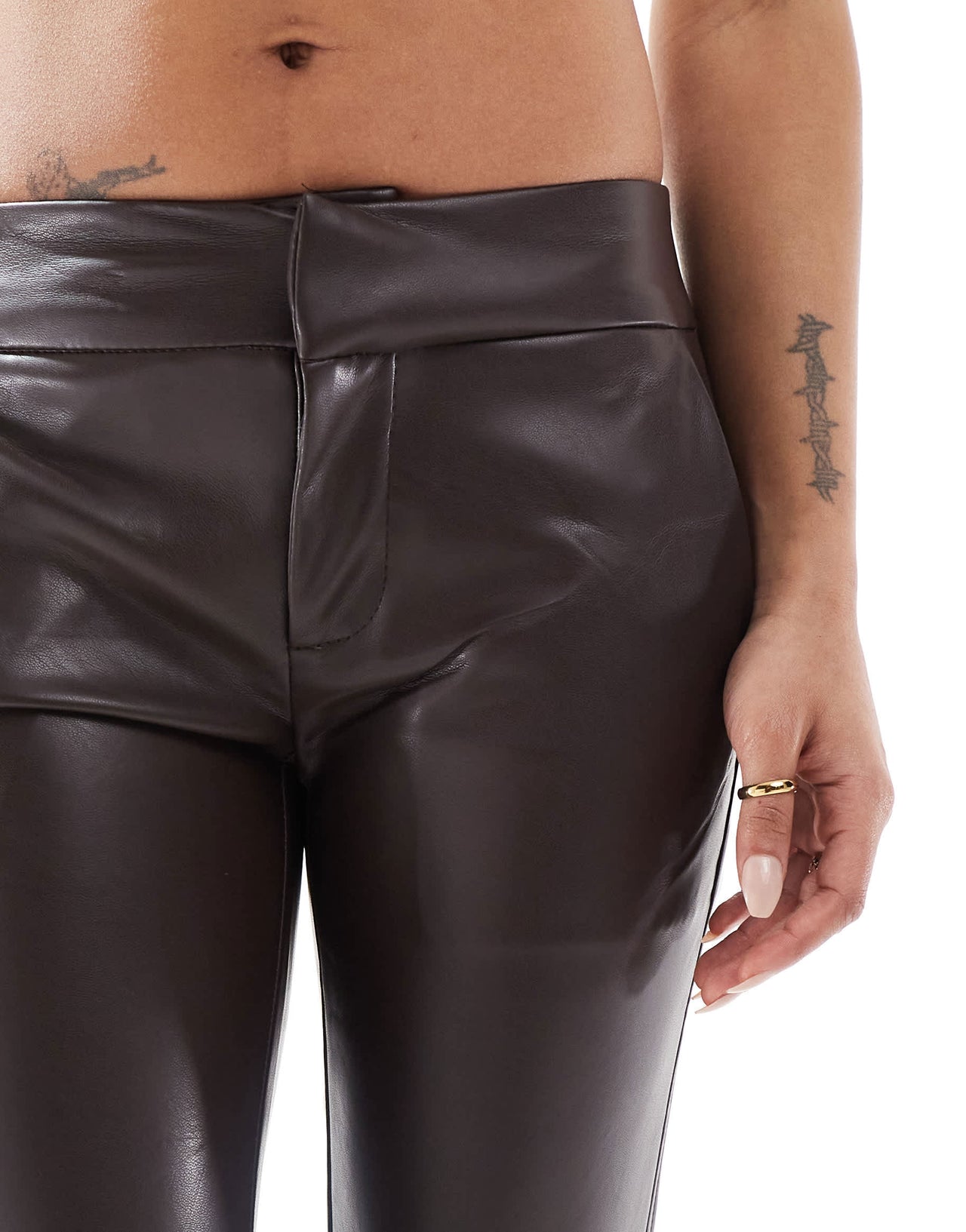 Bershka Petite faux leather flared trousers in brown