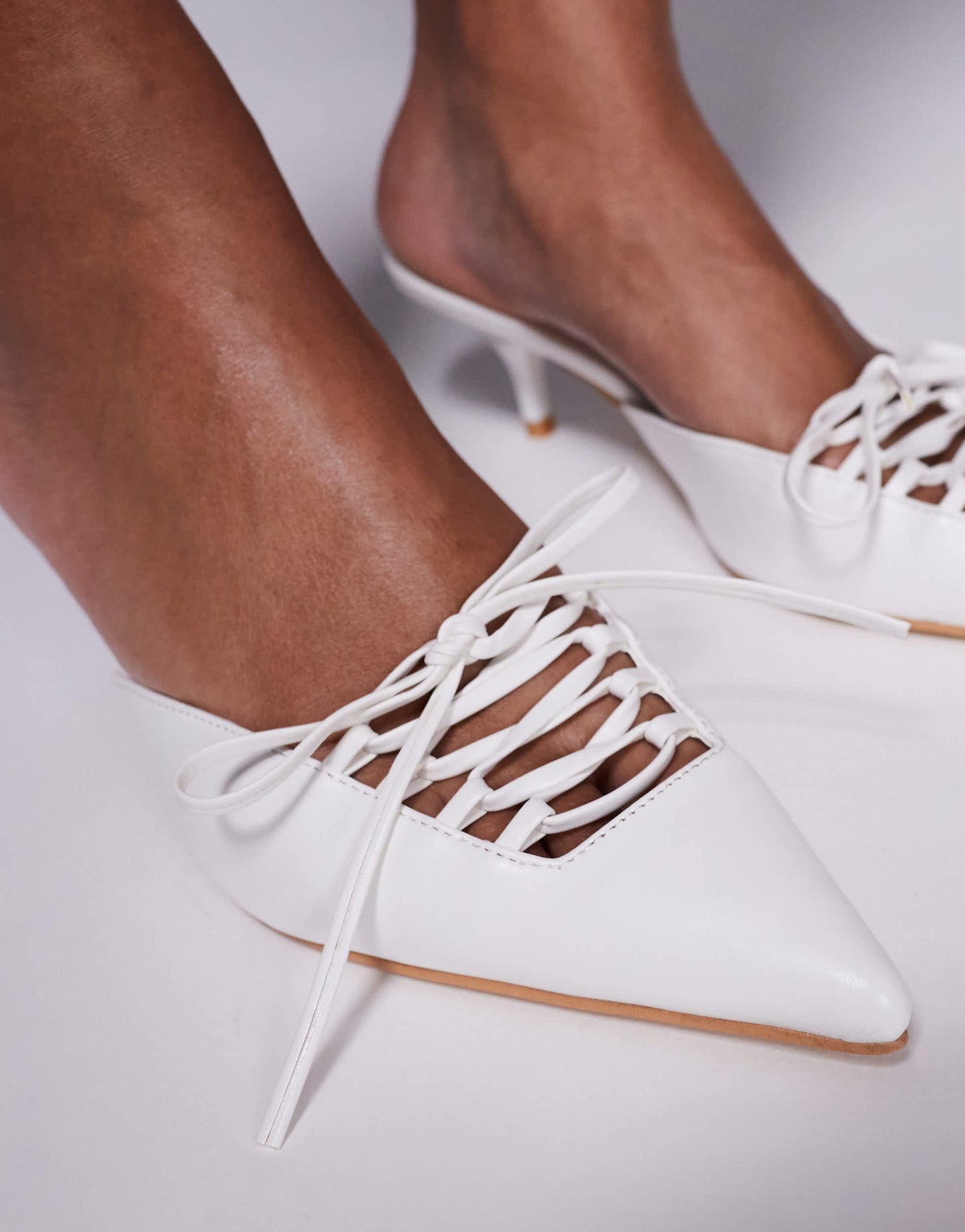 Public Desire Geneva pointed kitten heel mules with lace up in white