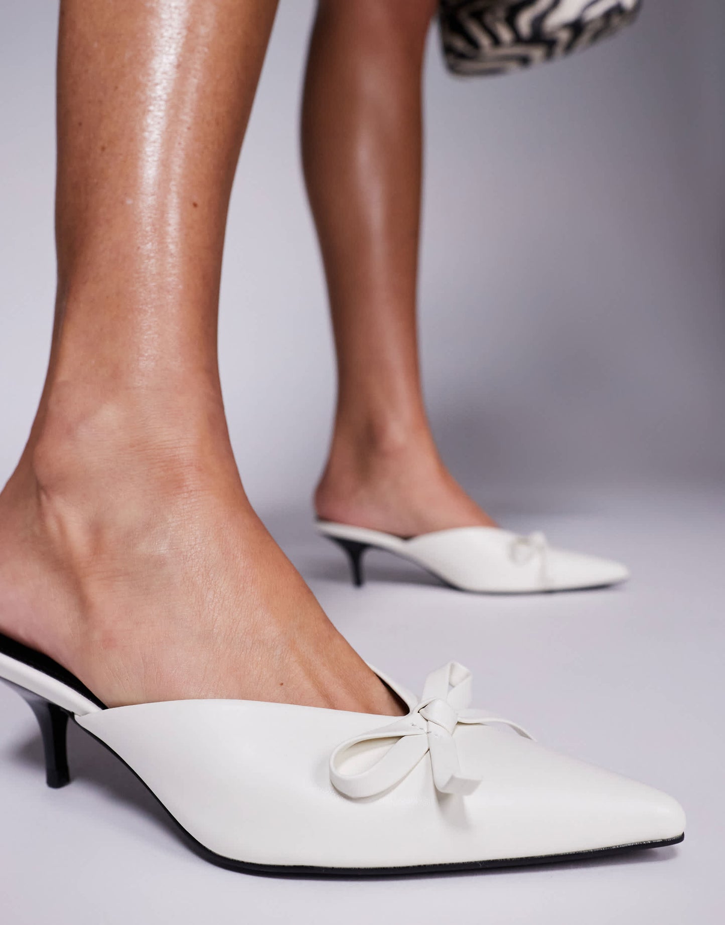 Public Desire Lionheart pointed kitten heel mules with bow in white