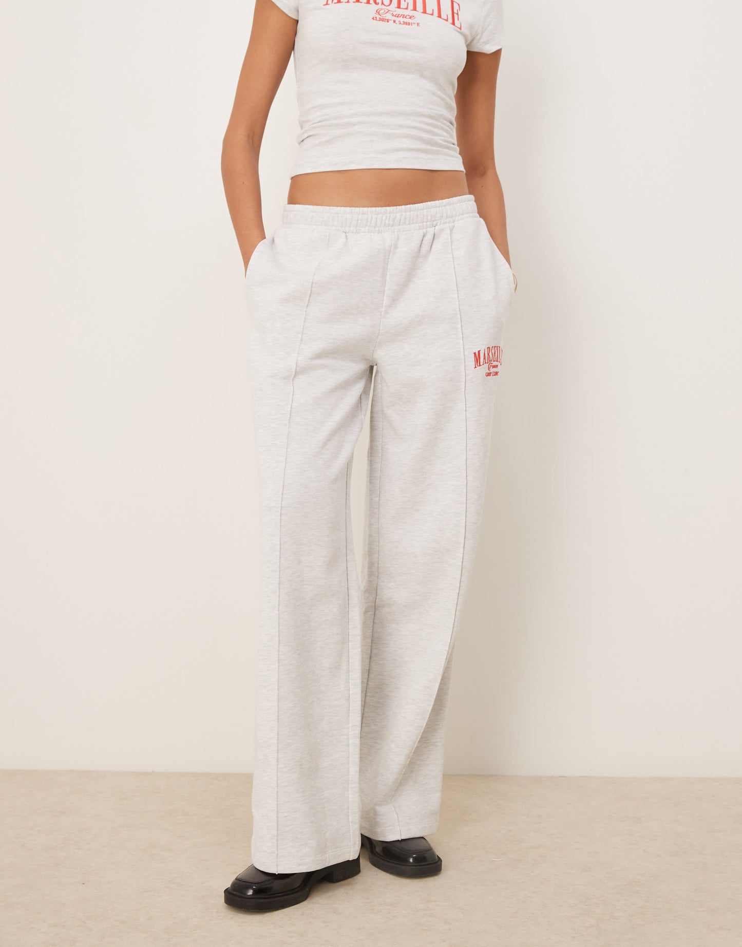 ASOS DESIGN straight leg jogger with Marseille embroidered graphic in ice marl