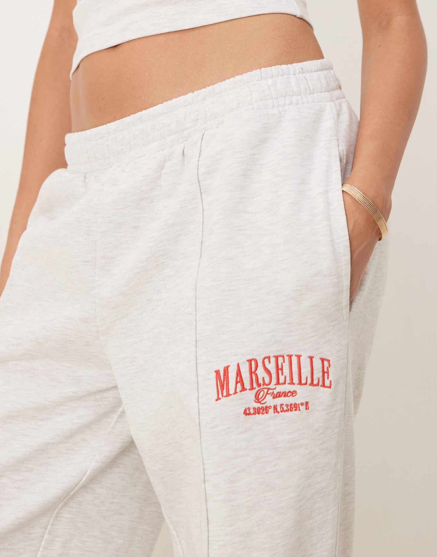 ASOS DESIGN straight leg jogger with Marseille embroidered graphic in ice marl