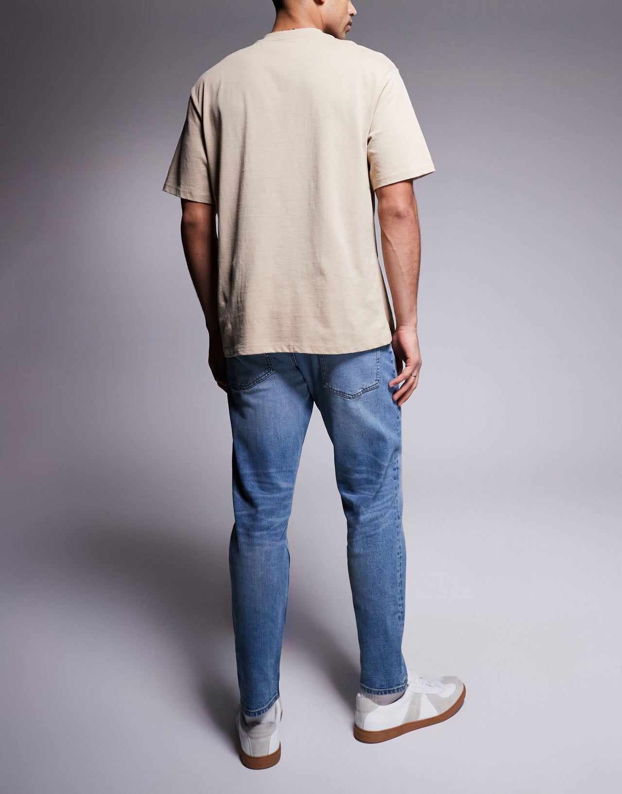 ASOS DSIGN stretch tapered jeans in mid wash with vintage tint