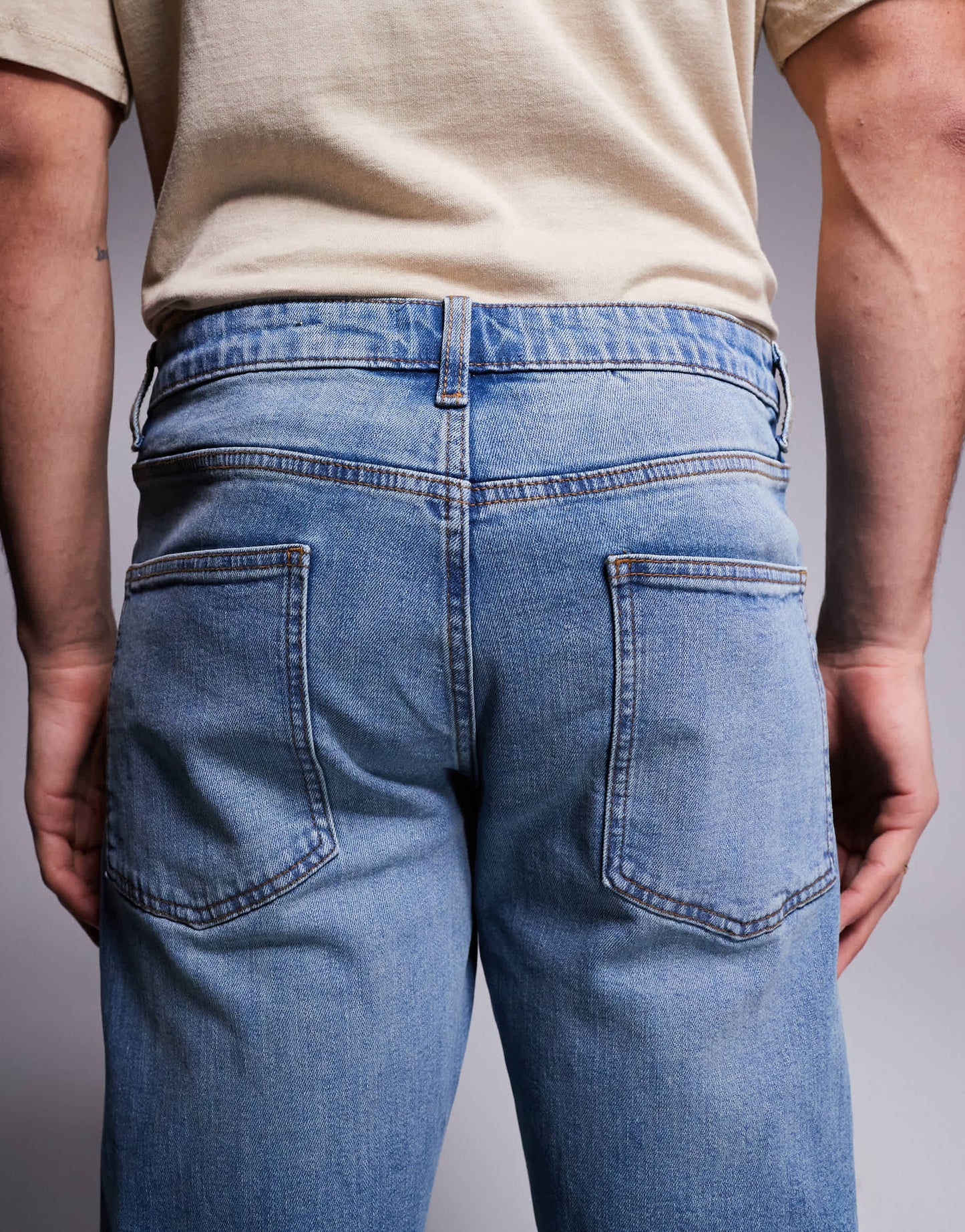 ASOS DSIGN stretch tapered jeans in mid wash with vintage tint