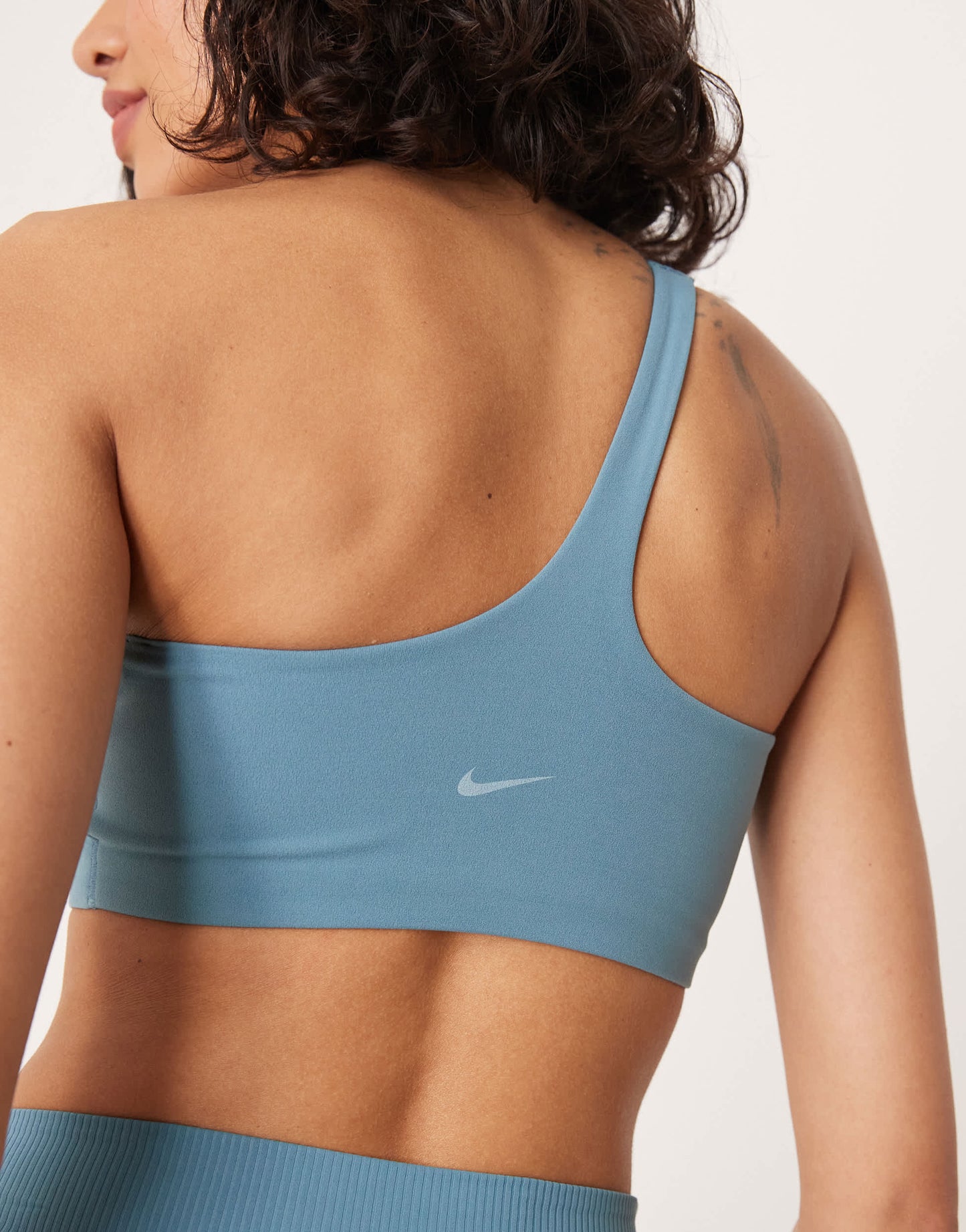 Nike Training Zenvy Dri-FIT soft touch asymmetric sports bra in blue
