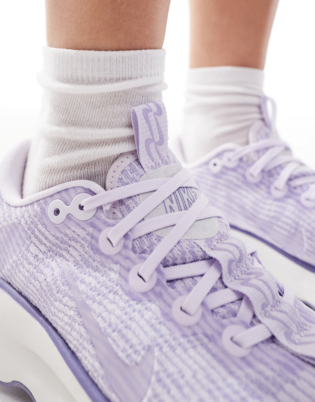 Nike Training Motiva trainers in lilac and white