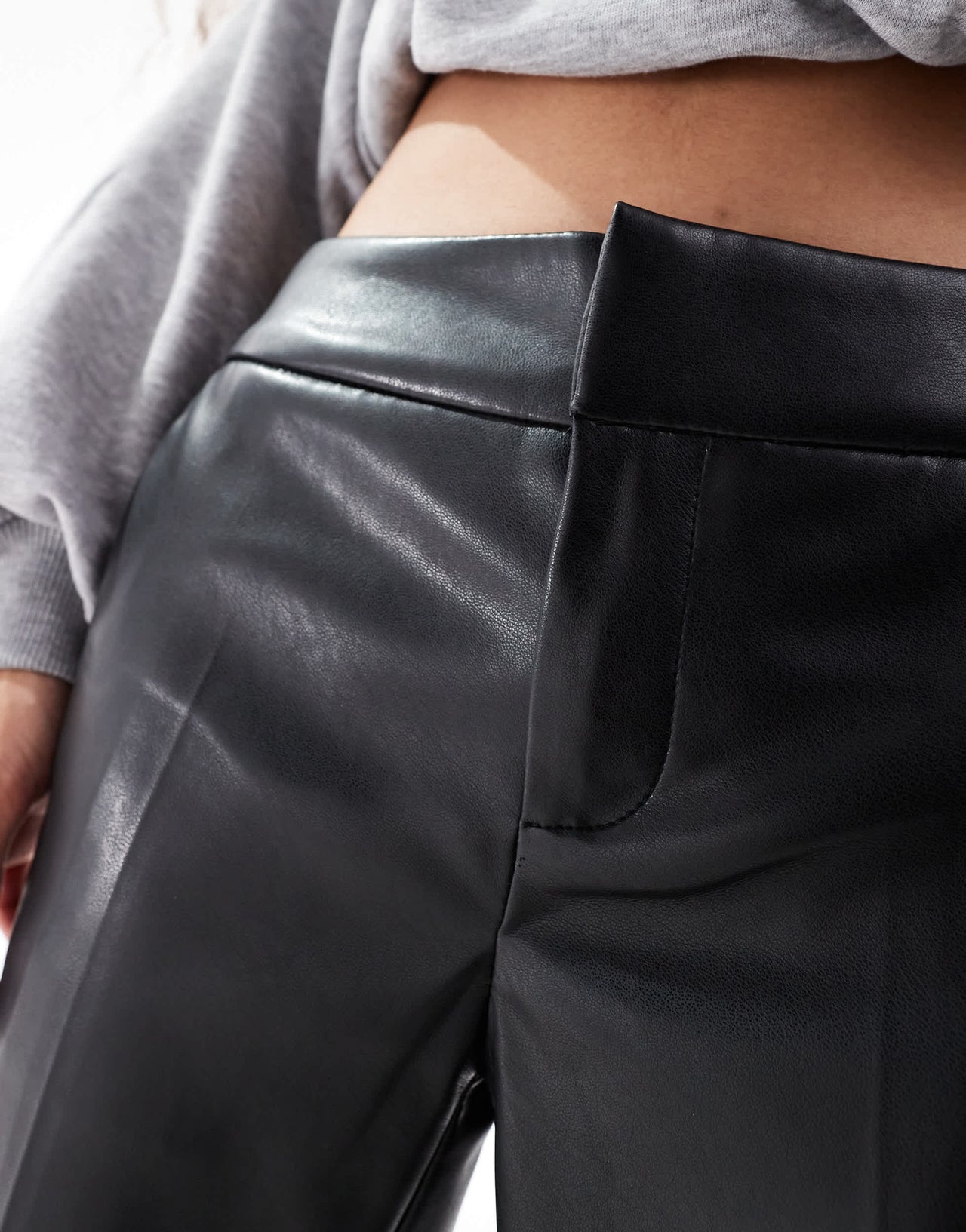 Bershka Petite faux leather flared trousers in black