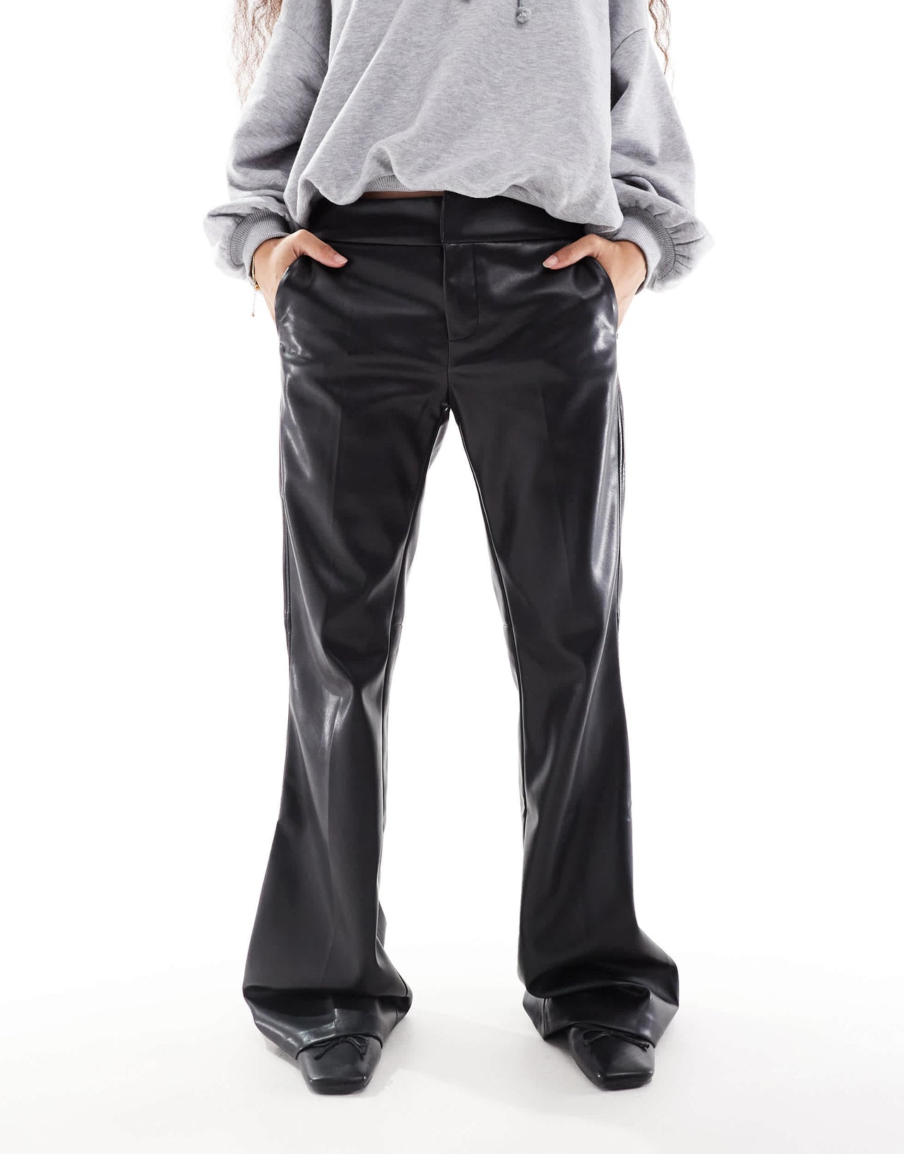 Bershka Petite faux leather flared trousers in black