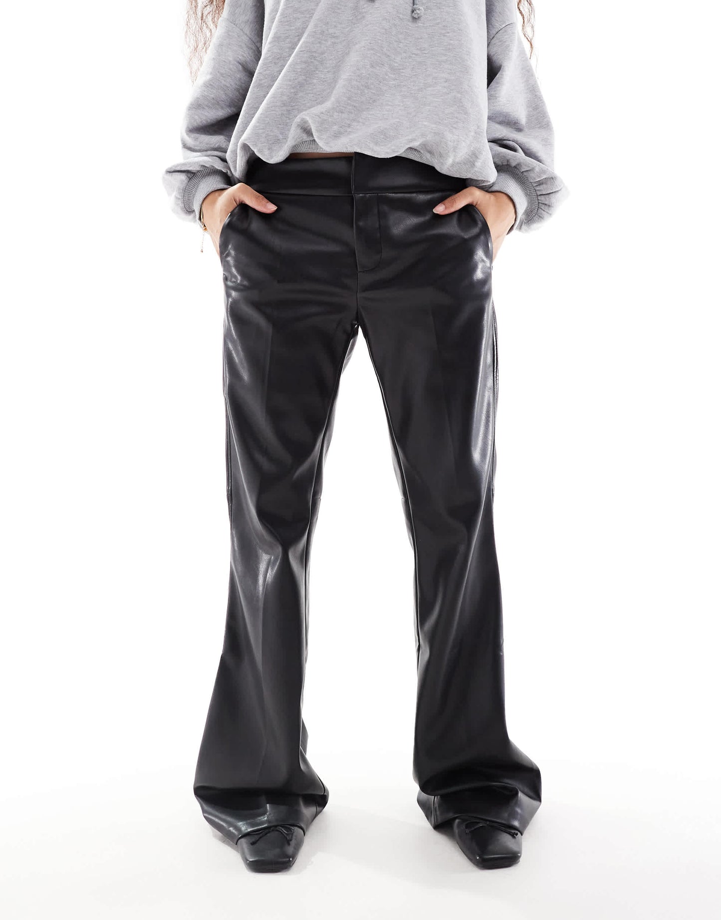 Bershka Petite faux leather flared trousers in black