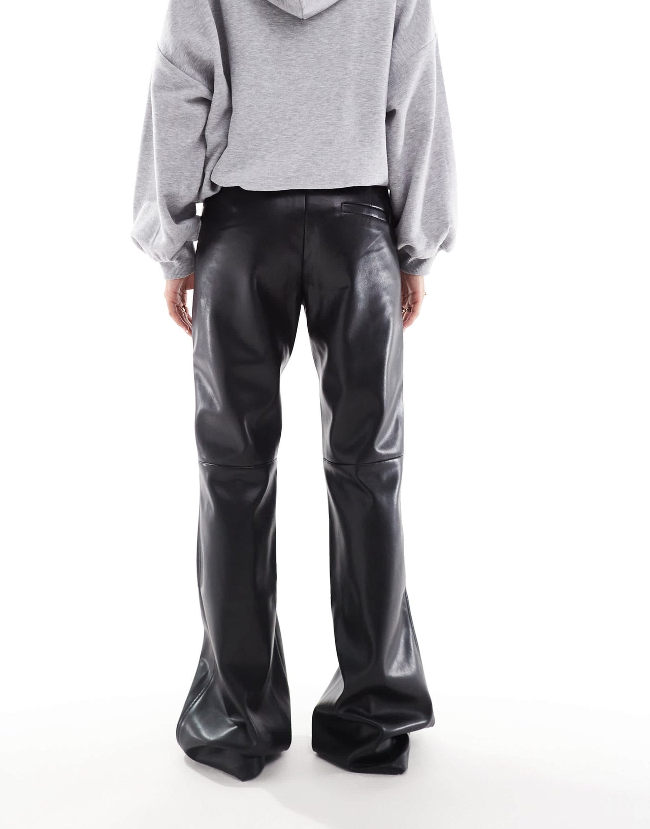 Bershka Petite faux leather flared trousers in black