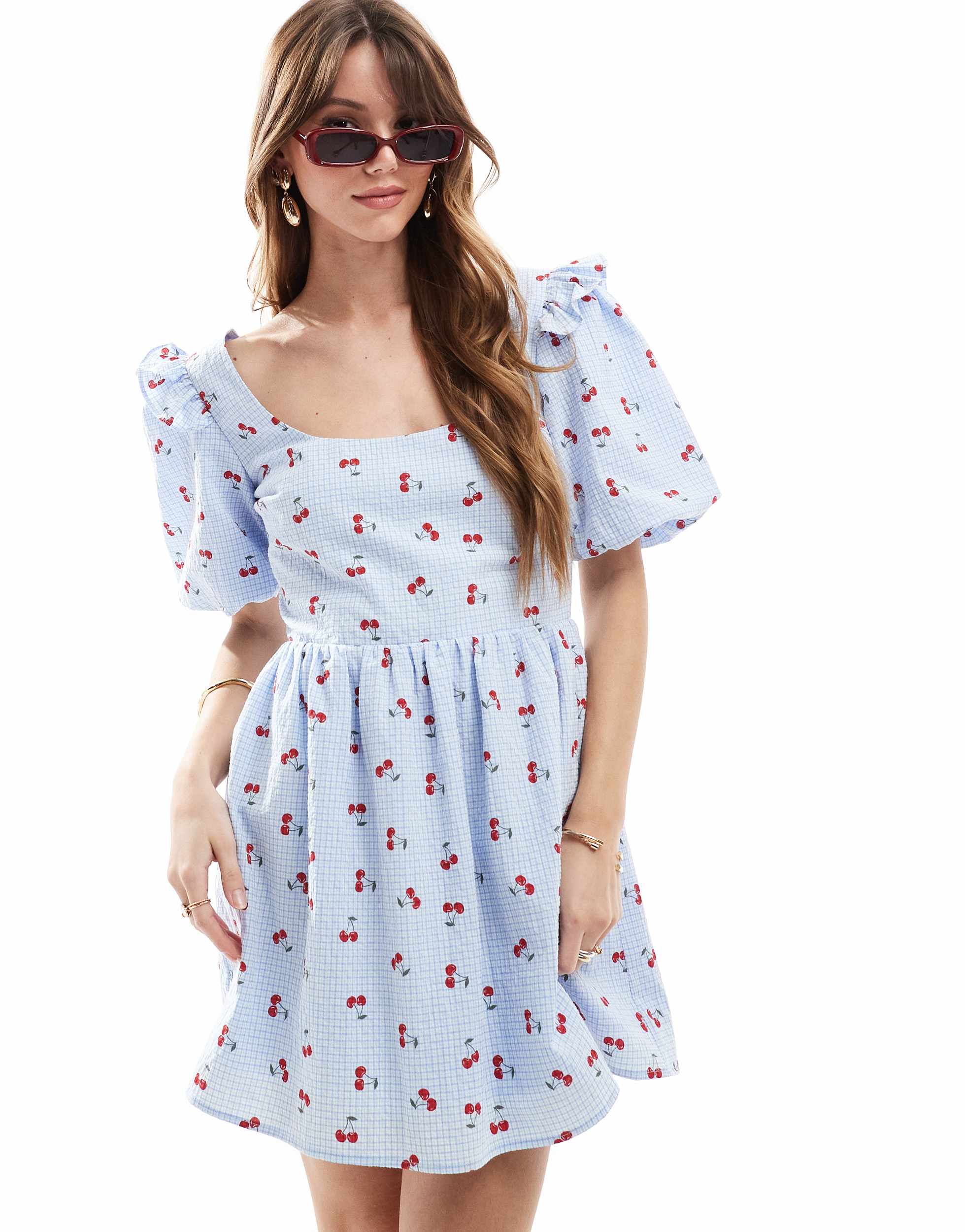 The Frolic exclusive seersucker ruffle puff sleeve shirred babydoll mini dress in blue check and cherry print