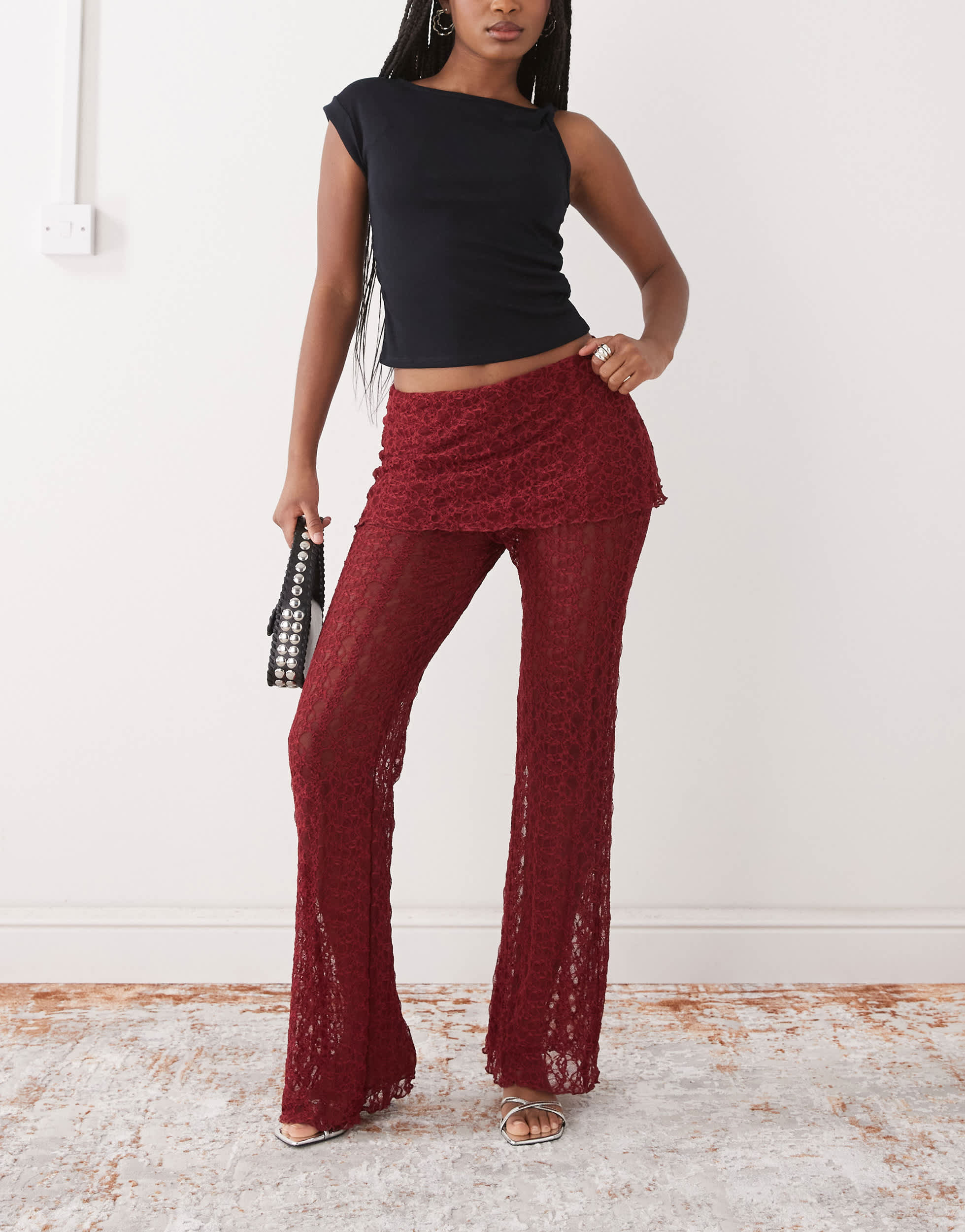 Noisy May lace skirt over trousers in dark red