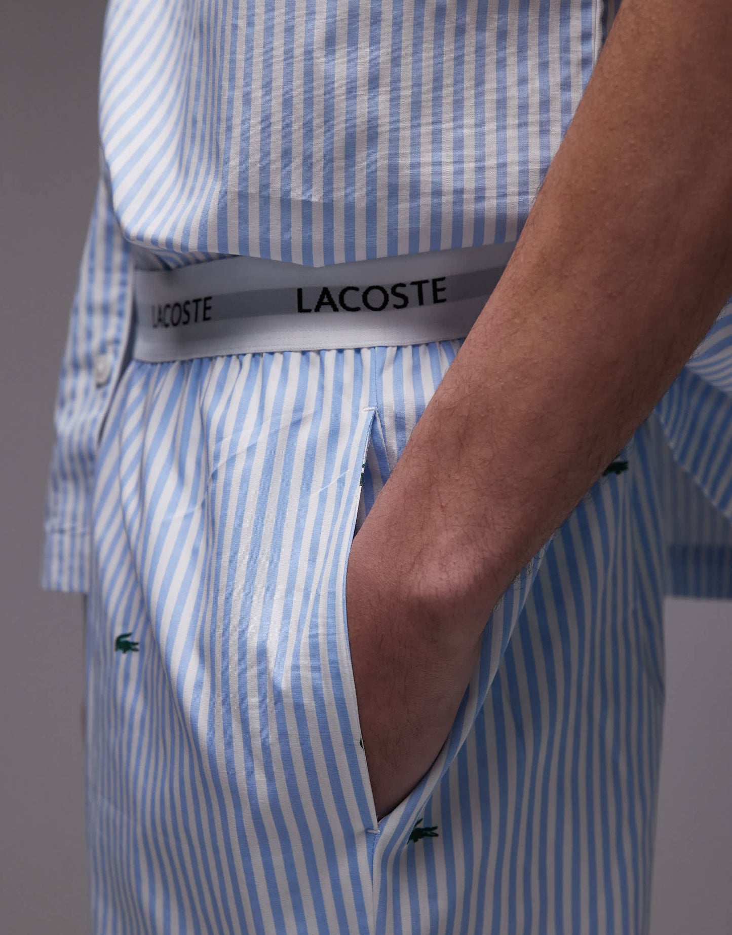 Lacoste loungewear trousers in light blue with all over croc print
