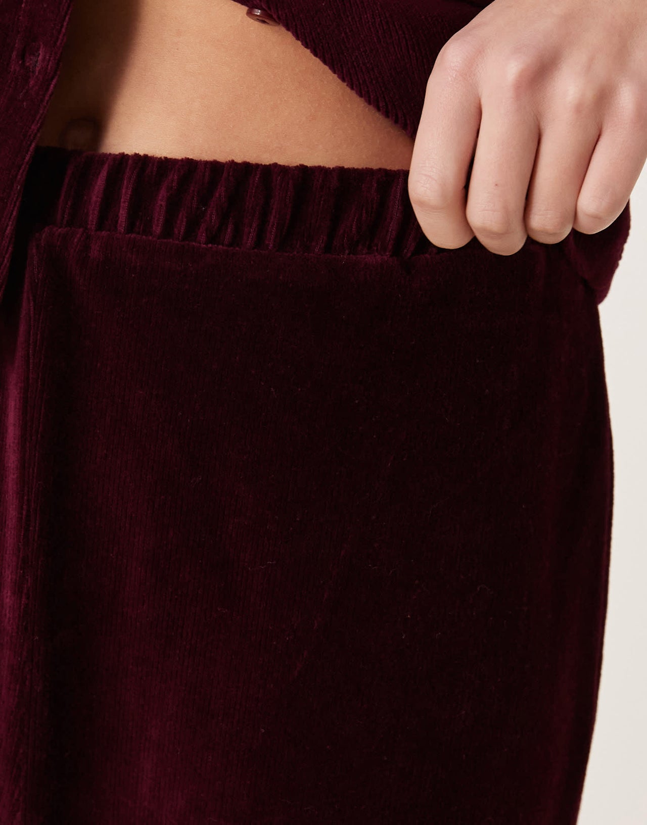 ASOS DESIGN wide leg velvet cord trousers in burgundy