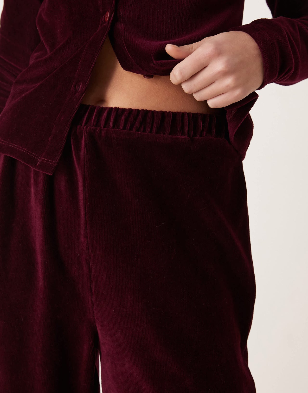 ASOS DESIGN wide leg velvet cord trousers in burgundy
