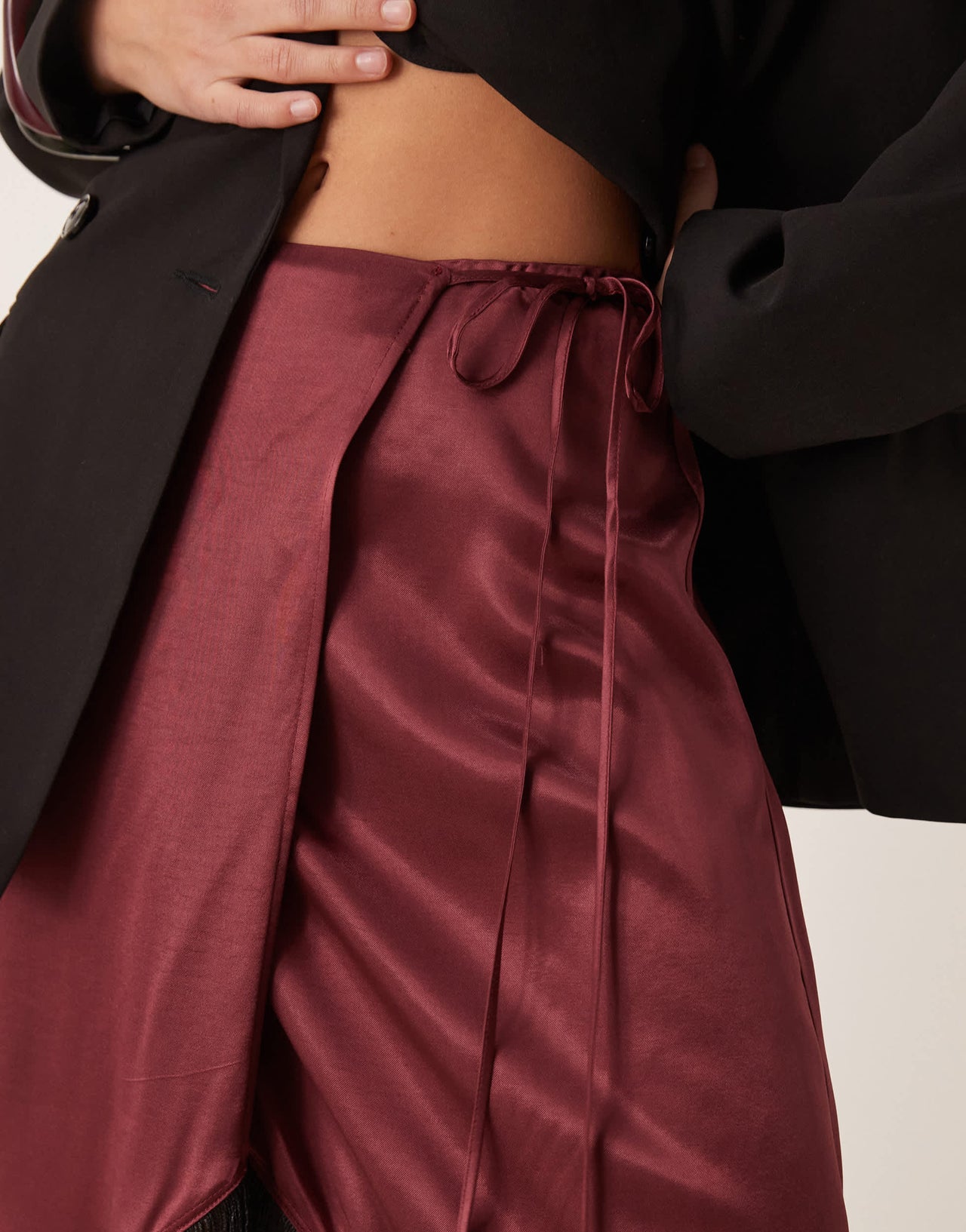 ASOS DESIGN satin wrap skirt with fringe hem in burgundy